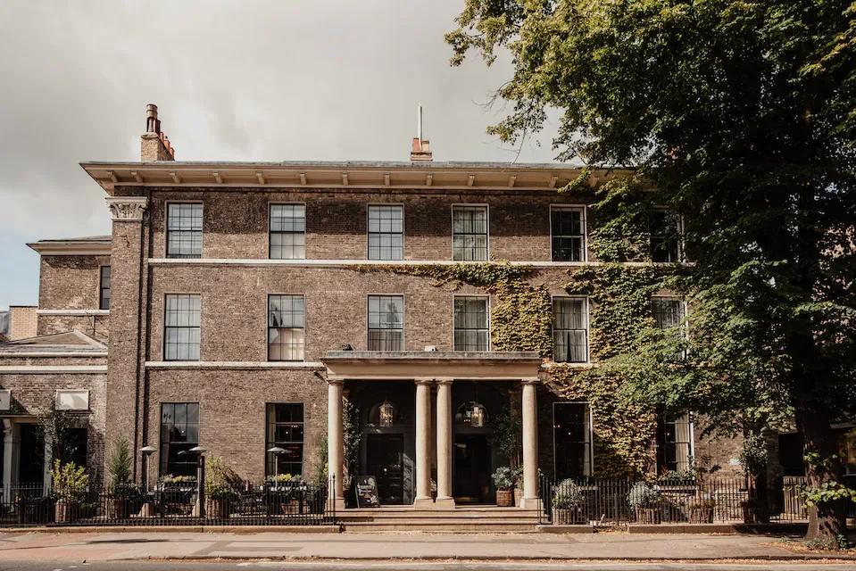 Front of No 1 Guesthouse York, a large brick building with a tree to the right