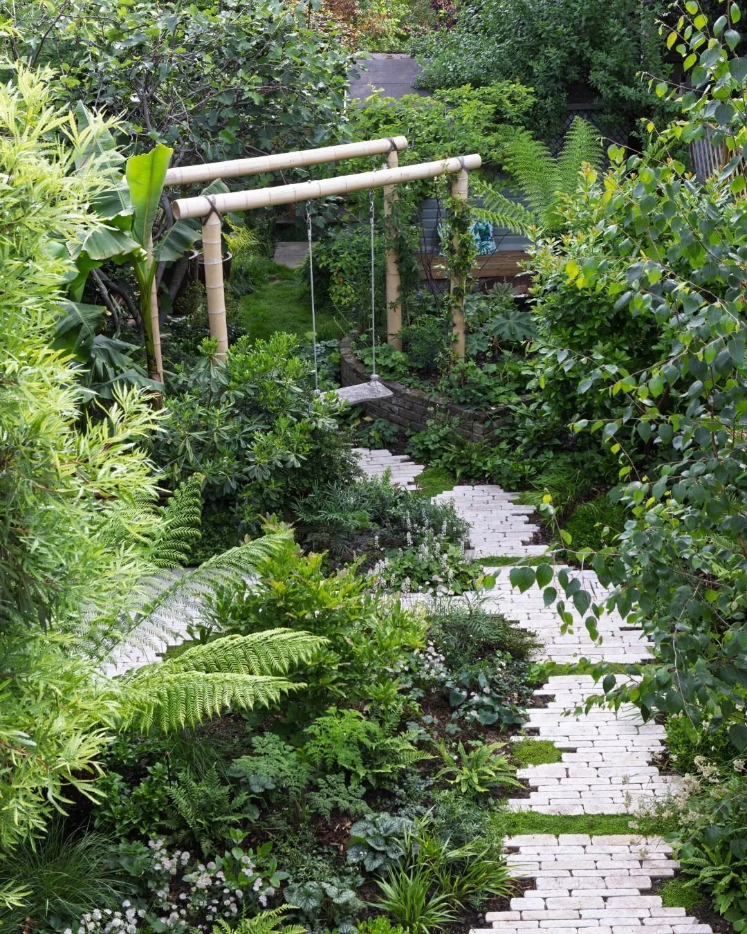 Can you believe that this vibrant green oasis is nestled right within the heart of the city?

The lush foliage bursts with life, while a charming wooden swing invites you to relax and unwind. The enchanting scene is elevated by our Zahra Beige Pitche