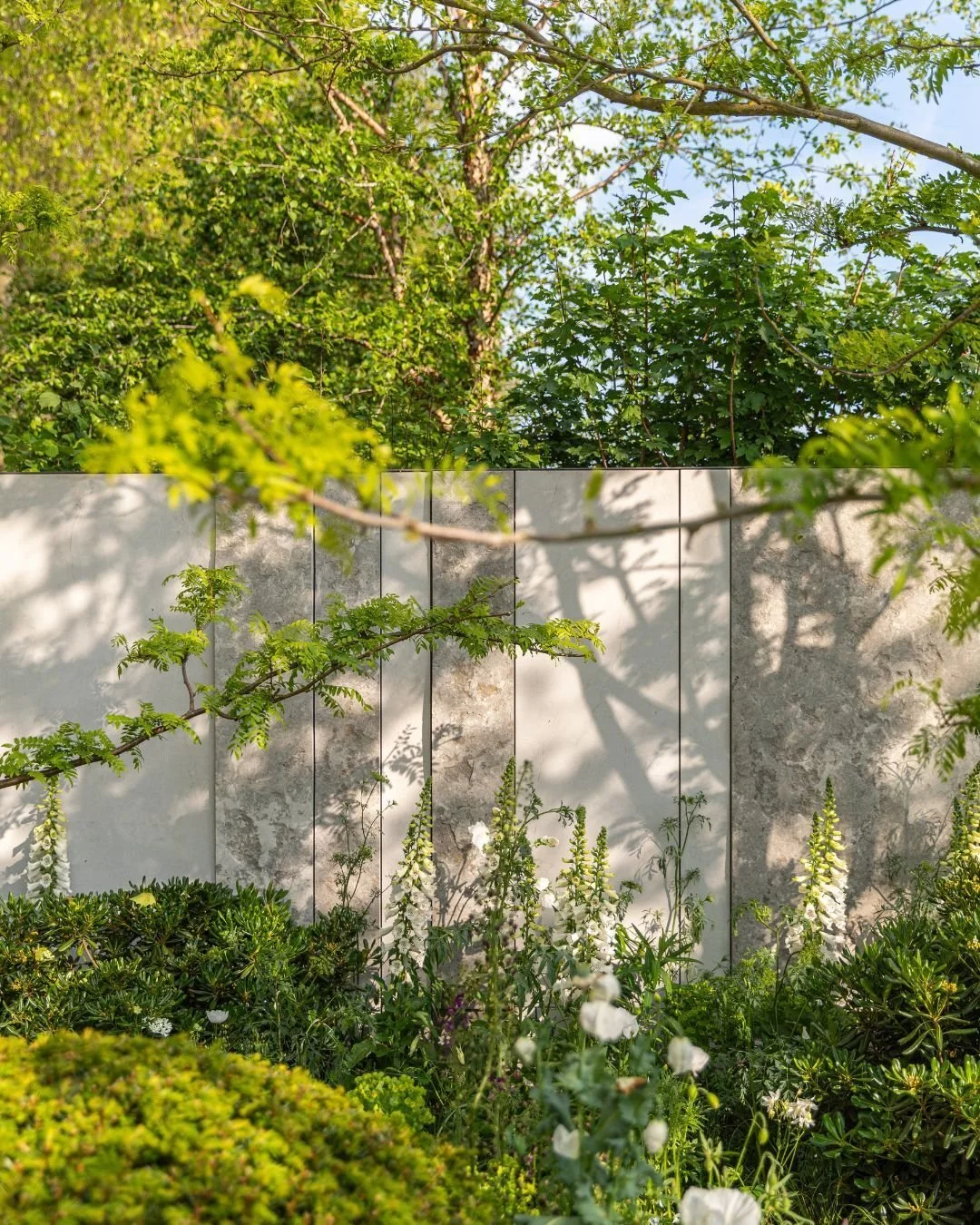 This is our gorgeous Porto Weathered Riven, a unique limestone that brings dimension and depth to any landscape. Its rustic finish invites you to take a closer look at the intricate details, as seen in these photos of Porto from the Transcendence Gar