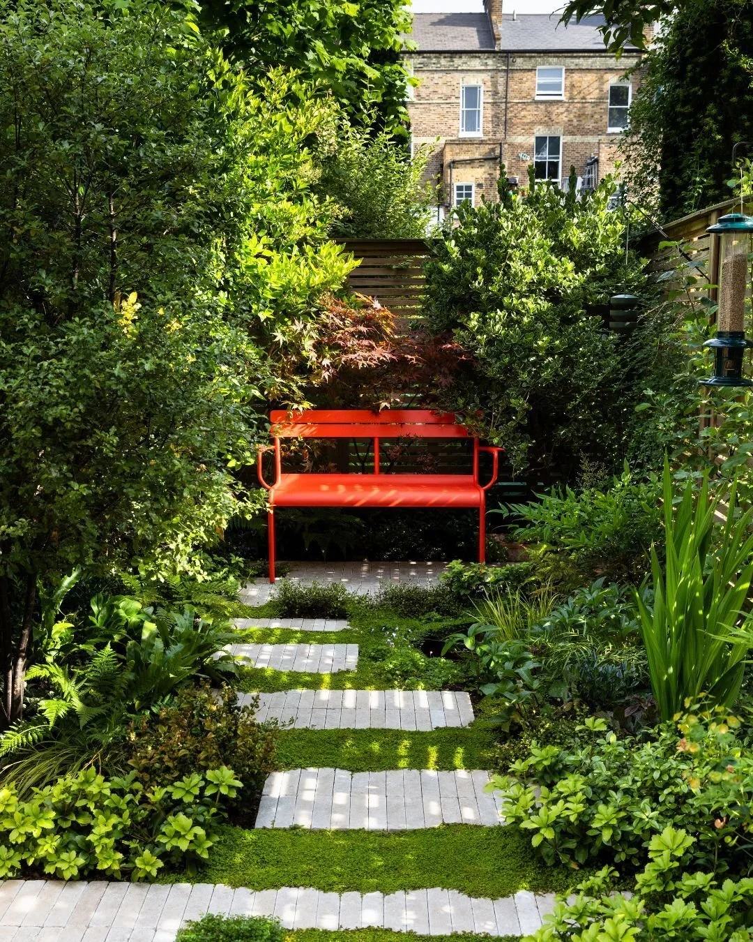 A peaceful pocket garden designed for slowing down 💚

Our beautiful Zahra Beige Stackers guide you through the garden to the bold red bench, creating a natural focal point and a perfect place to pause and unwind. 

Credits:
Design @eastlondongardend