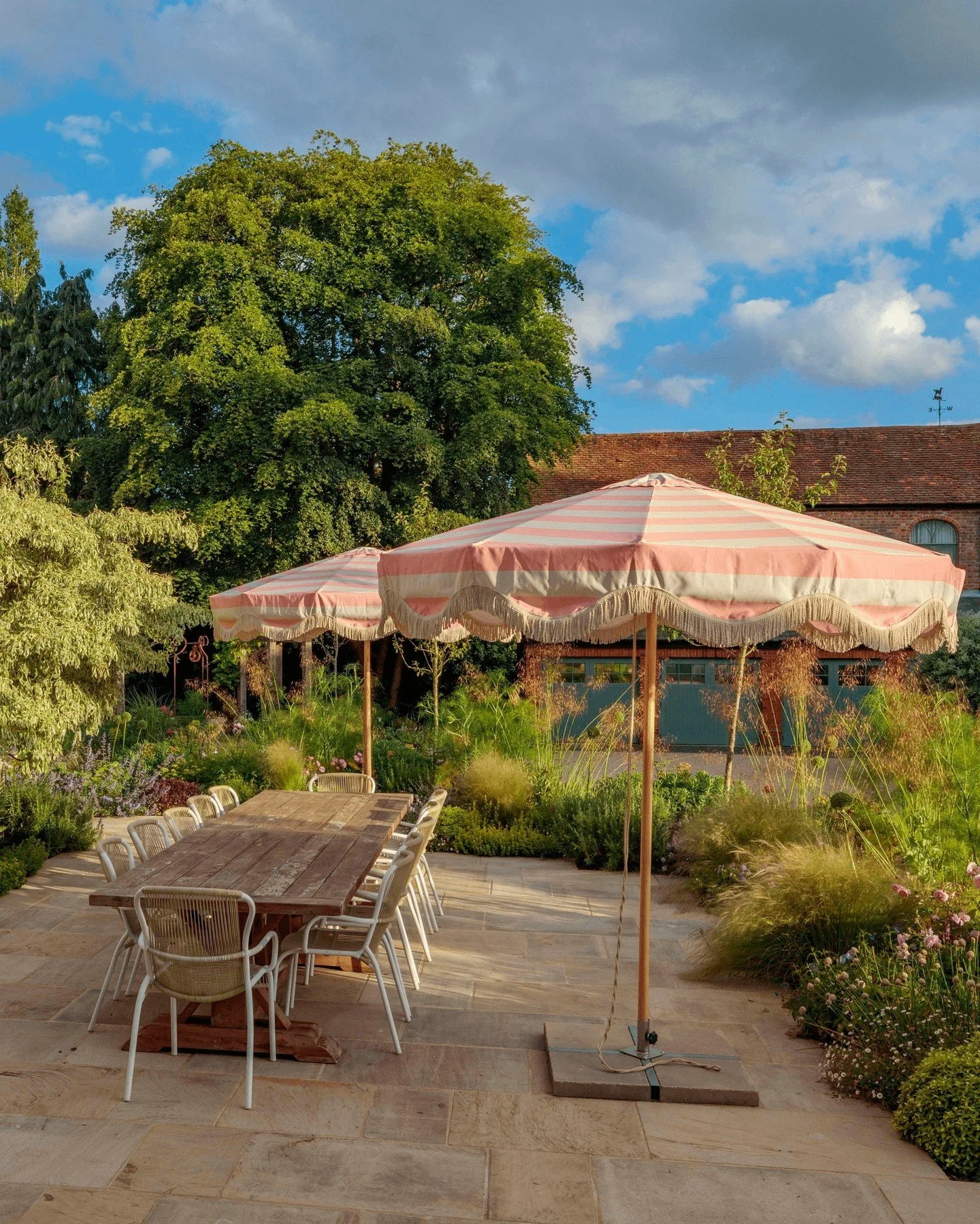 We find ourselves drawn to this gorgeous Hertfordshire garden ✨ 

Apperley Antique paving beautifully complements the warm tones of the outdoor furniture, while subtly enhancing the soft pink hues of the parasols and surrounding lush planting. In suc