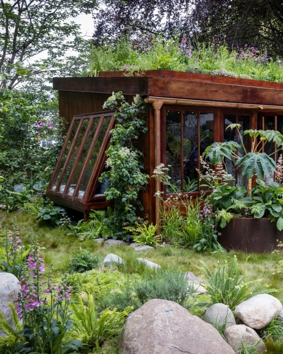 This is The Composer&rsquo;s Cabin, a Silver medal winning garden that combines music and horticulture, inspired by the lush Cornish landscapes. 

Nestled amongst lush planting, grasses and flowers, our Glacial Boulder, Blueheart Stepping Stones and 