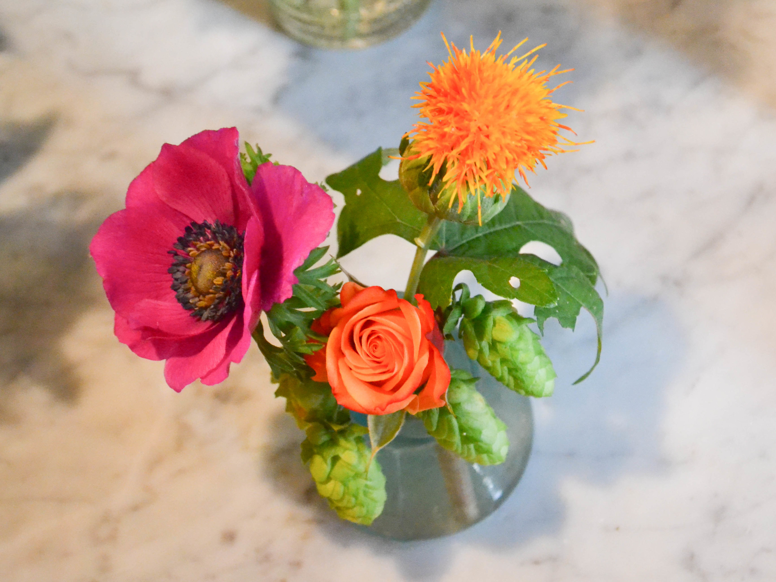 Bud vase arrangement in vintage aqua glass vase. Rosehip Social Brooklyn NY
