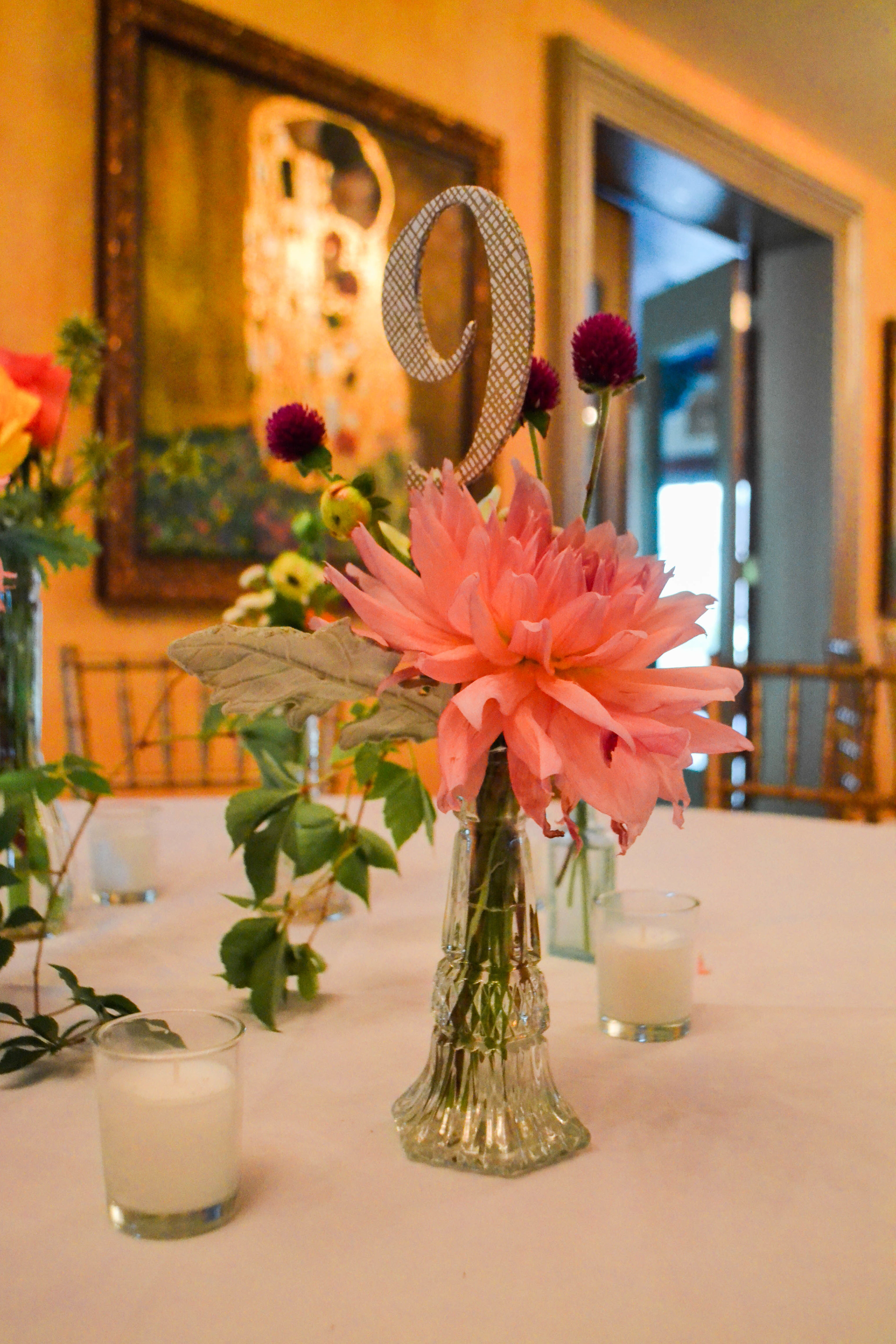 Colorful and romantic flower centerpiece in bud vase bottle. Catskills wedding. August.