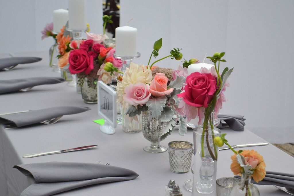 Peach toned dahlias and garden rose centerpiece with silvery greens and raspberry pink accent flowers. Foundry LIC wedding. Rosehip Brooklyn