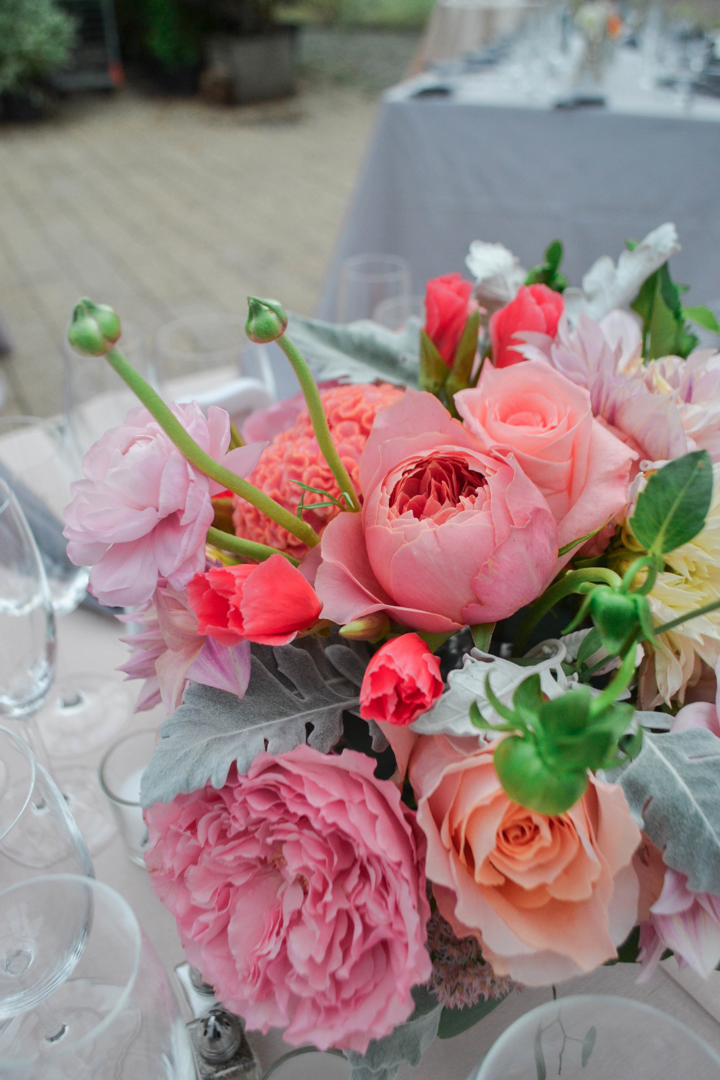 Peach toned dahlias and garden rose centerpiece with silvery greens and raspberry pink accent flowers. Foundry LIC wedding. Rosehip Brooklyn