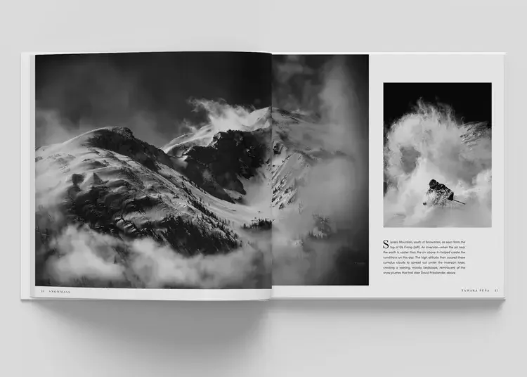 Open magazine featuring black and white mountain landscape and a skier in action with snow spray.