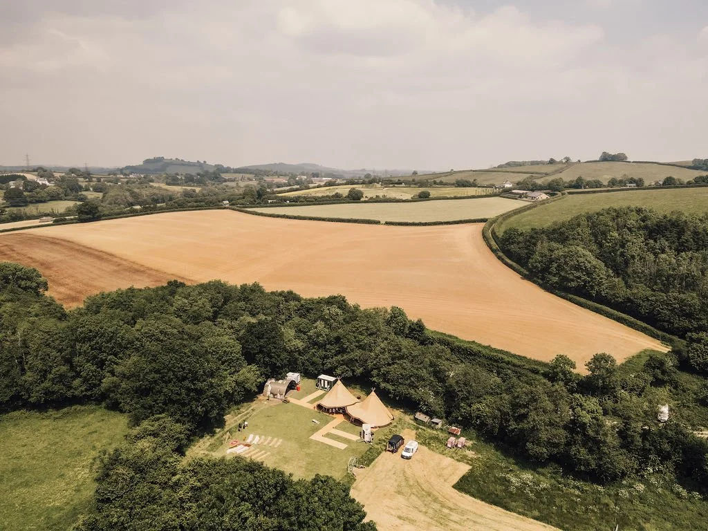 Giant tipi wedding setup in a countryside field in South West UK