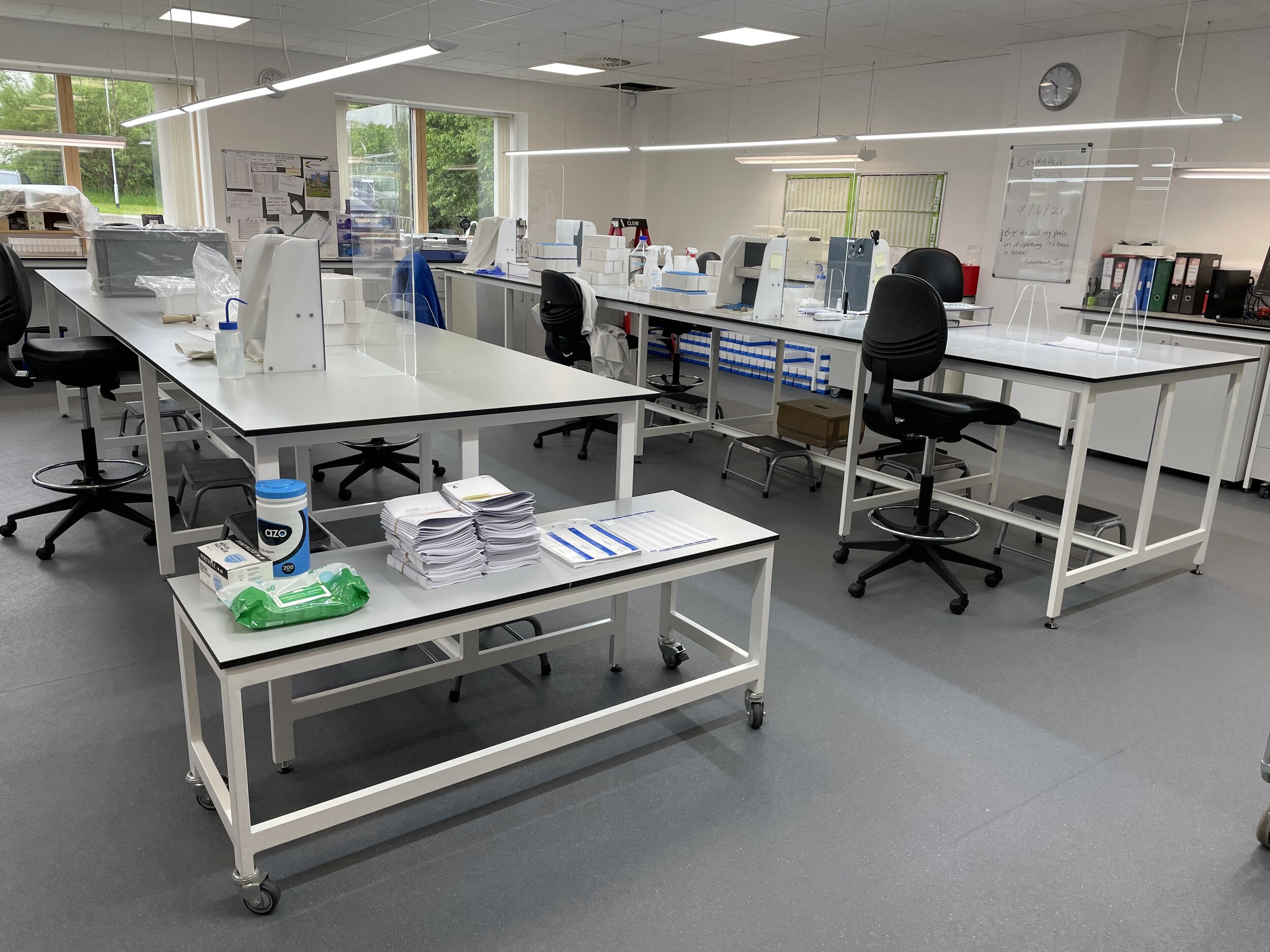 Laboratory with grey benching on which frames with a low level mobile table.