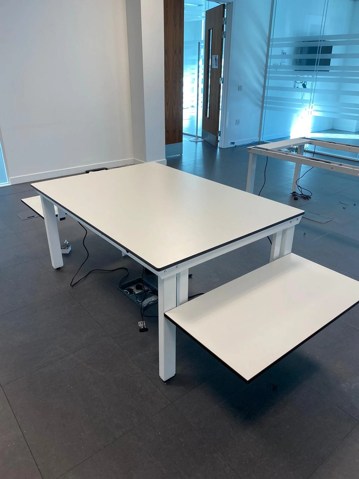 Adjustable height desks and tables for ergonomic working.