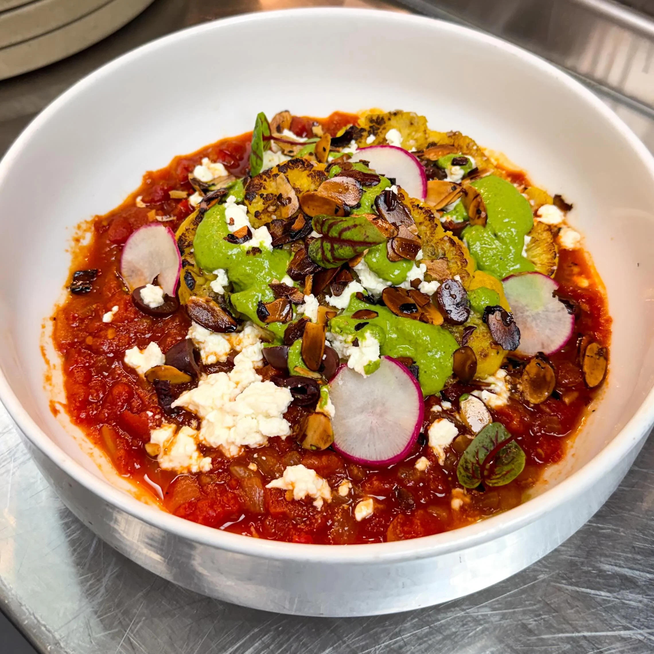 Color, comfort, and big flavor all in one dish.

Tonight&rsquo;s vegetarian appetizer feature:
Rainbow Cauliflower Shakshouka 🌈 with herb tahini, feta, kalamata olives, and almonds &mdash; rich, savory, bright, and perfect for a cozy dinner at Sage.