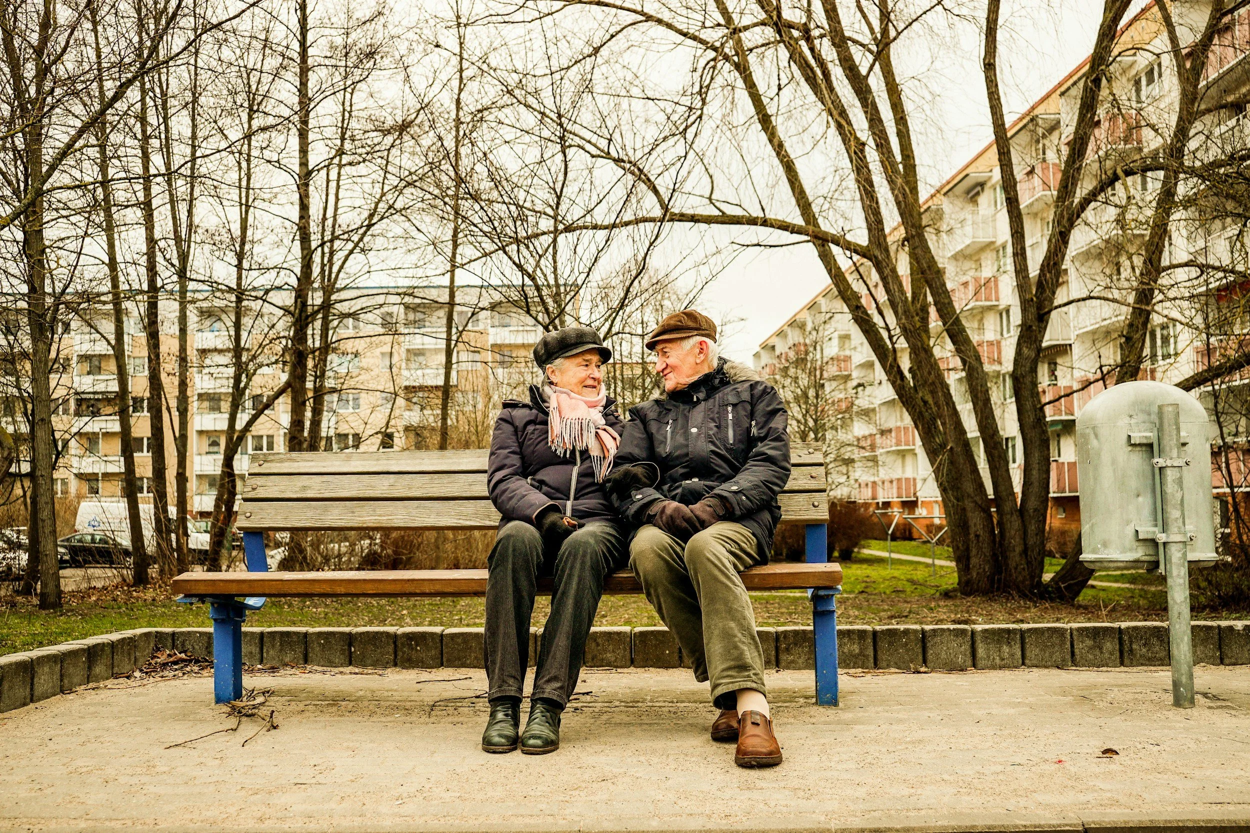 An older couple sitting together on a bench