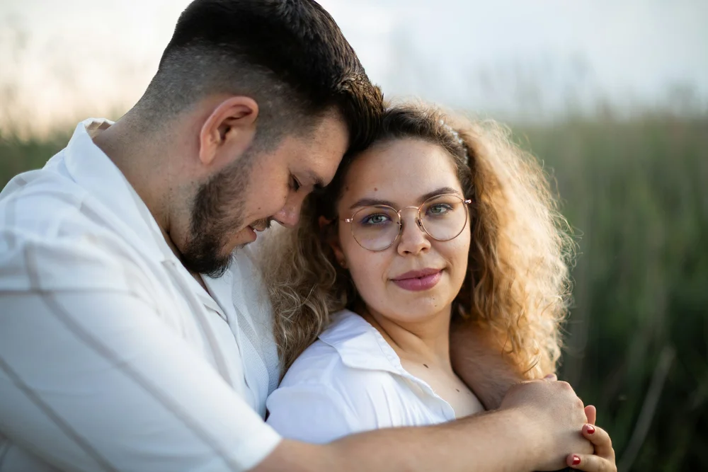A couple embracing in a field of reeds