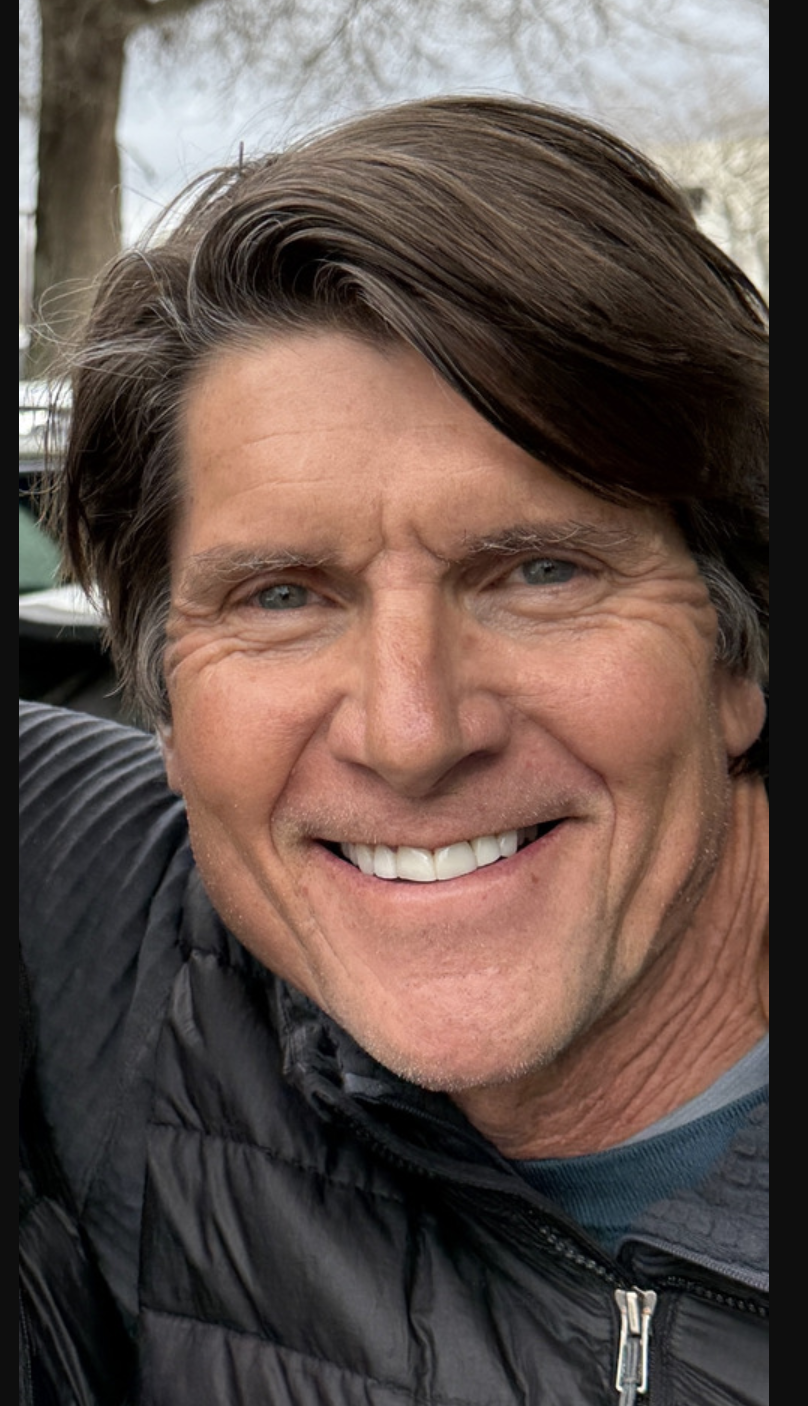 Rowlie Busch, smiling, in a dark puffer jacket outdoors