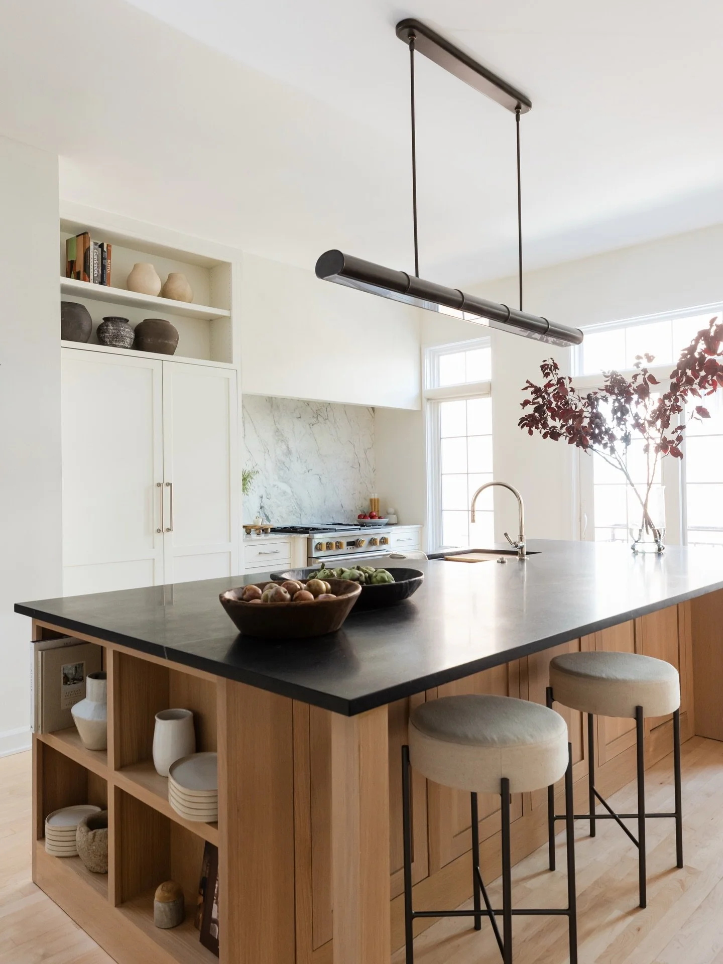 Another before and after of #projectspreadthelight where we took an awkward second fireplace and turned it into a stunning range and fridge wall for a now beautiful and functional kitchen! 

Designed and styled by @studiow_chicago
Photography by @yan