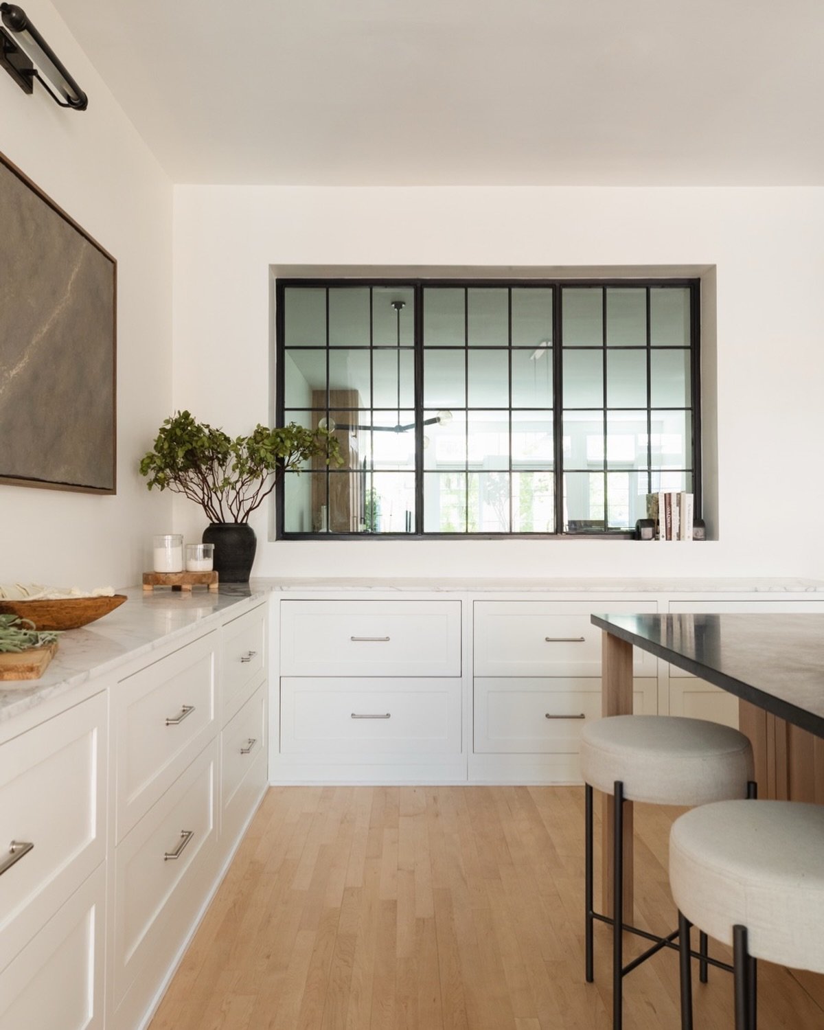 A moment for this stunning steel window by our favorite @iron_and_easel  which was the key to this renovation where we visually opened up the space but didn&rsquo;t change anything structurally #projectspreadthelight

Designed and styled by @studiow_