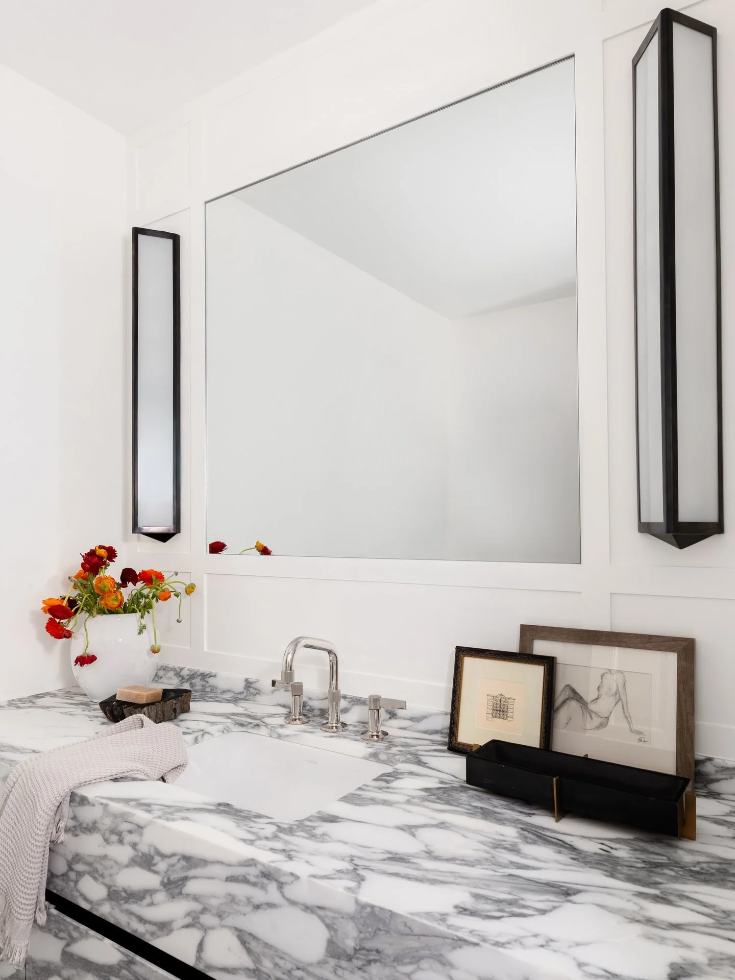 A before and after you won&rsquo;t believe! 

This custom vanity was designed to read as a solid stone block, while still maintaining fully functional drawers. A balance of materiality and function where the details feel seamless, but the usability i