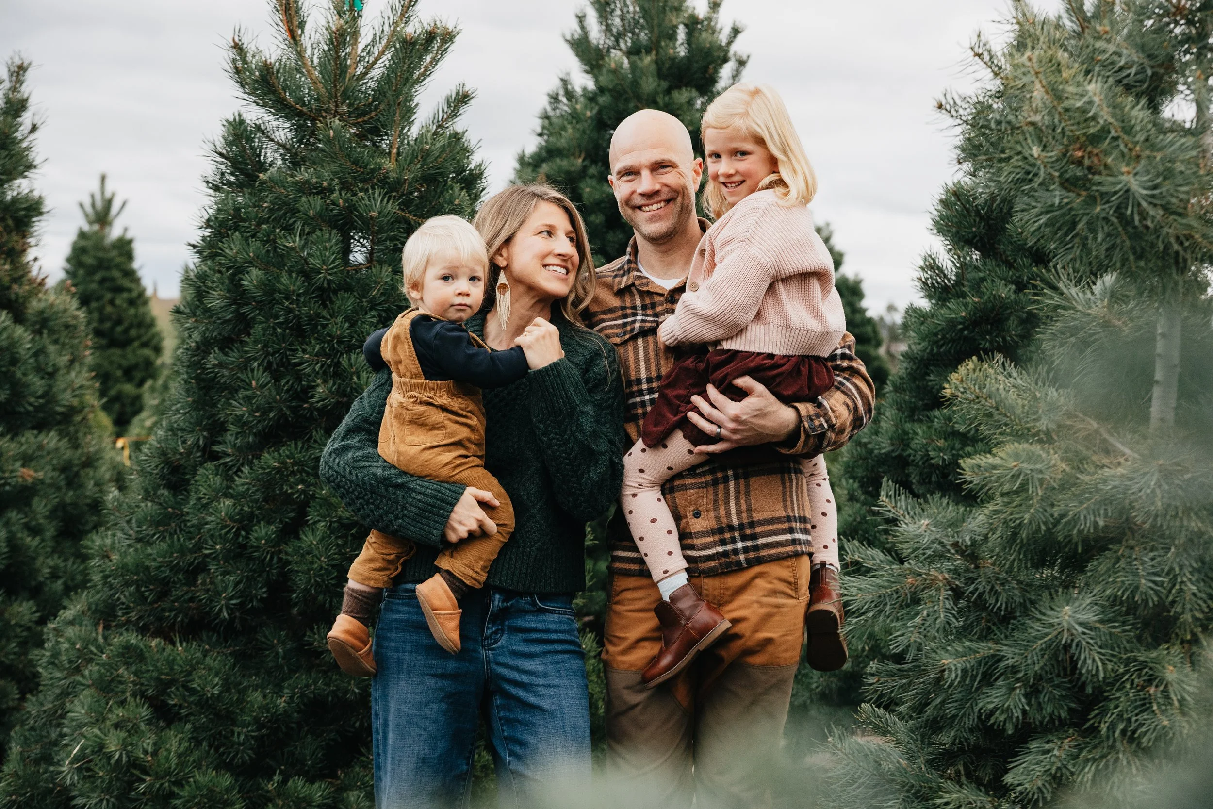 Missoula family photographer capturing families at a Montana Christmas tree farm, featuring cozy moments, winter light, and holiday connection.
