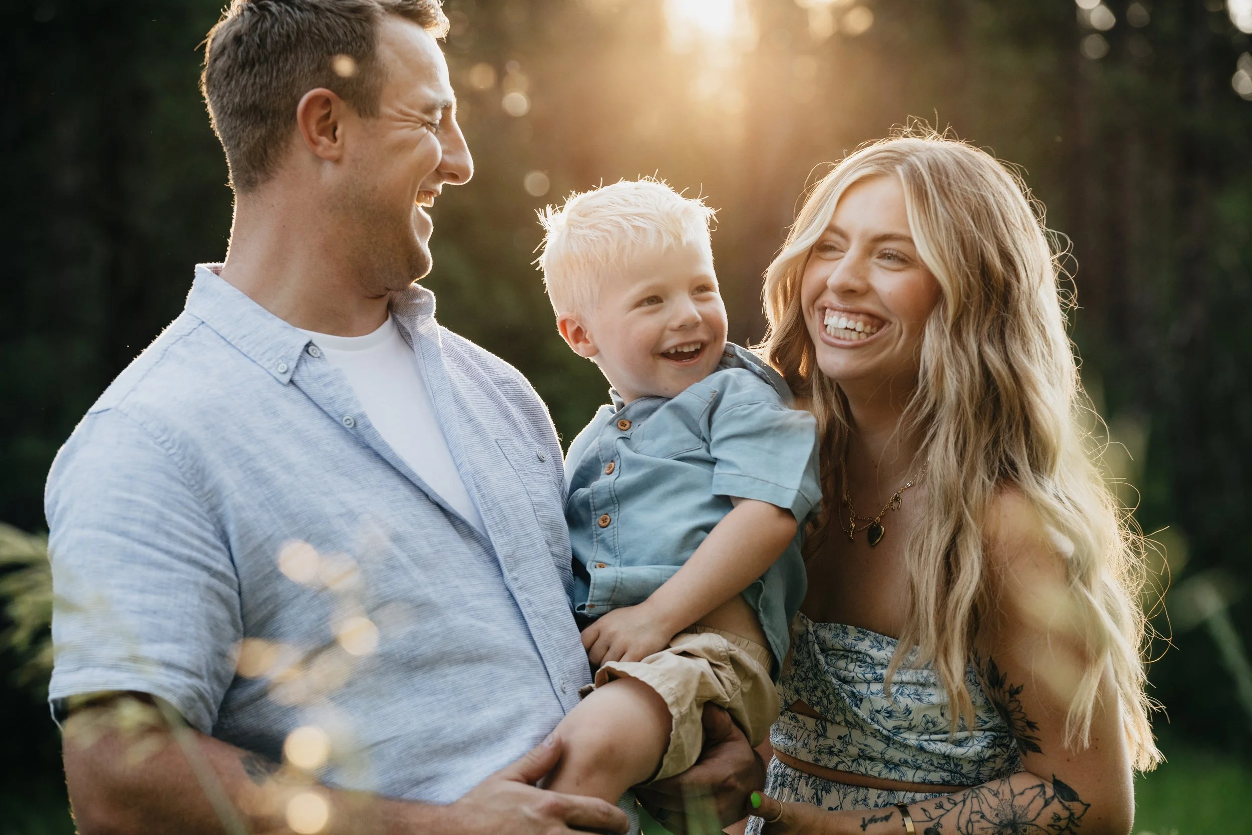 Montana family photographer offering summer family photos in Missoula, highlighting playful moments between parents and their young son outdoors.