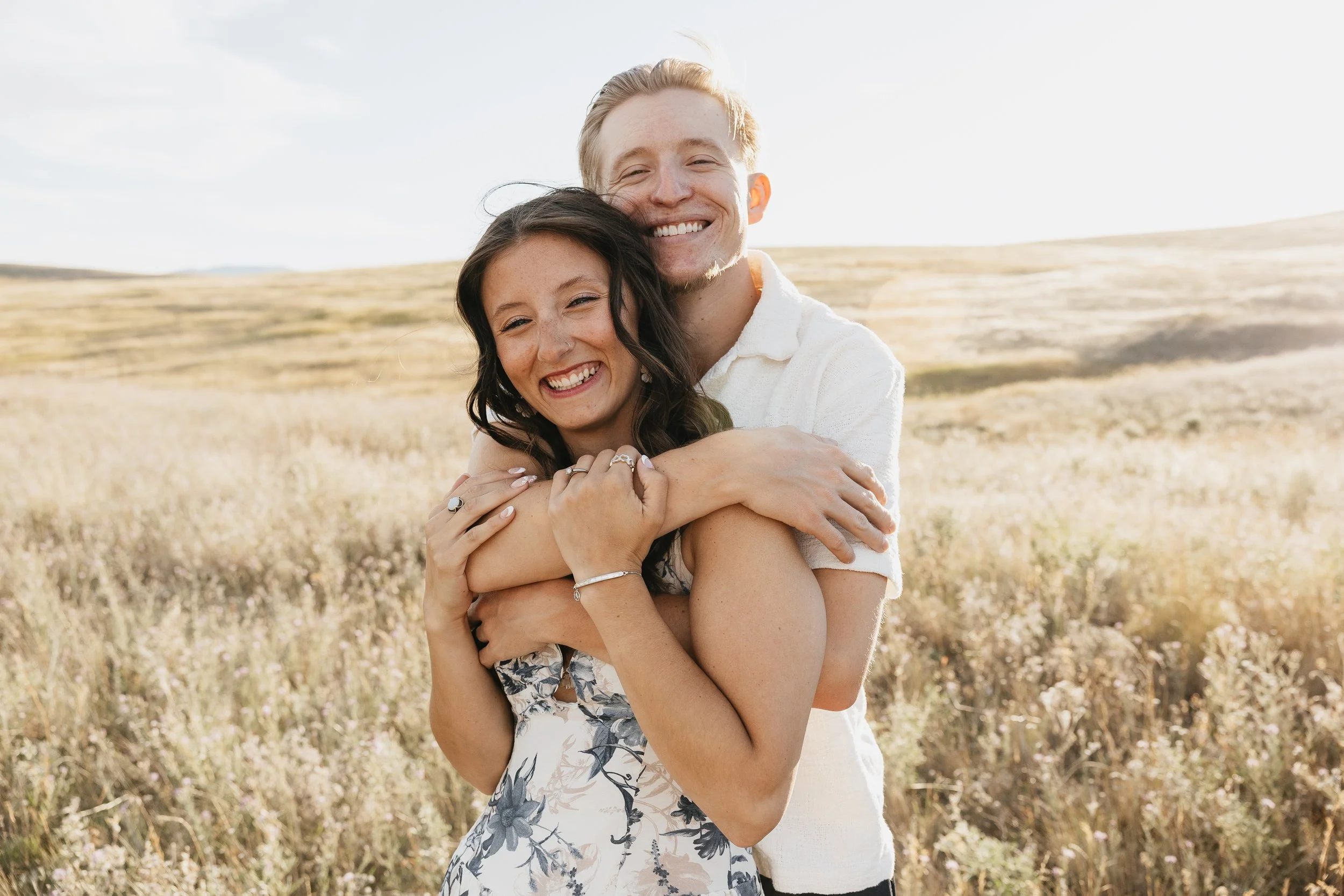 Engagement photos in Montana featuring big skies and open fields, capturing romantic couples in expansive landscapes with natural light.