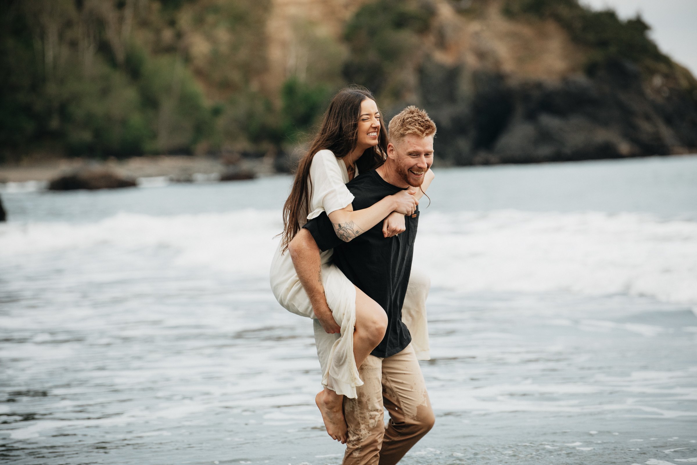 Candid engagement photos on the Oregon Coast highlighting emotional connection, open coastline, and timeless beach scenery.
