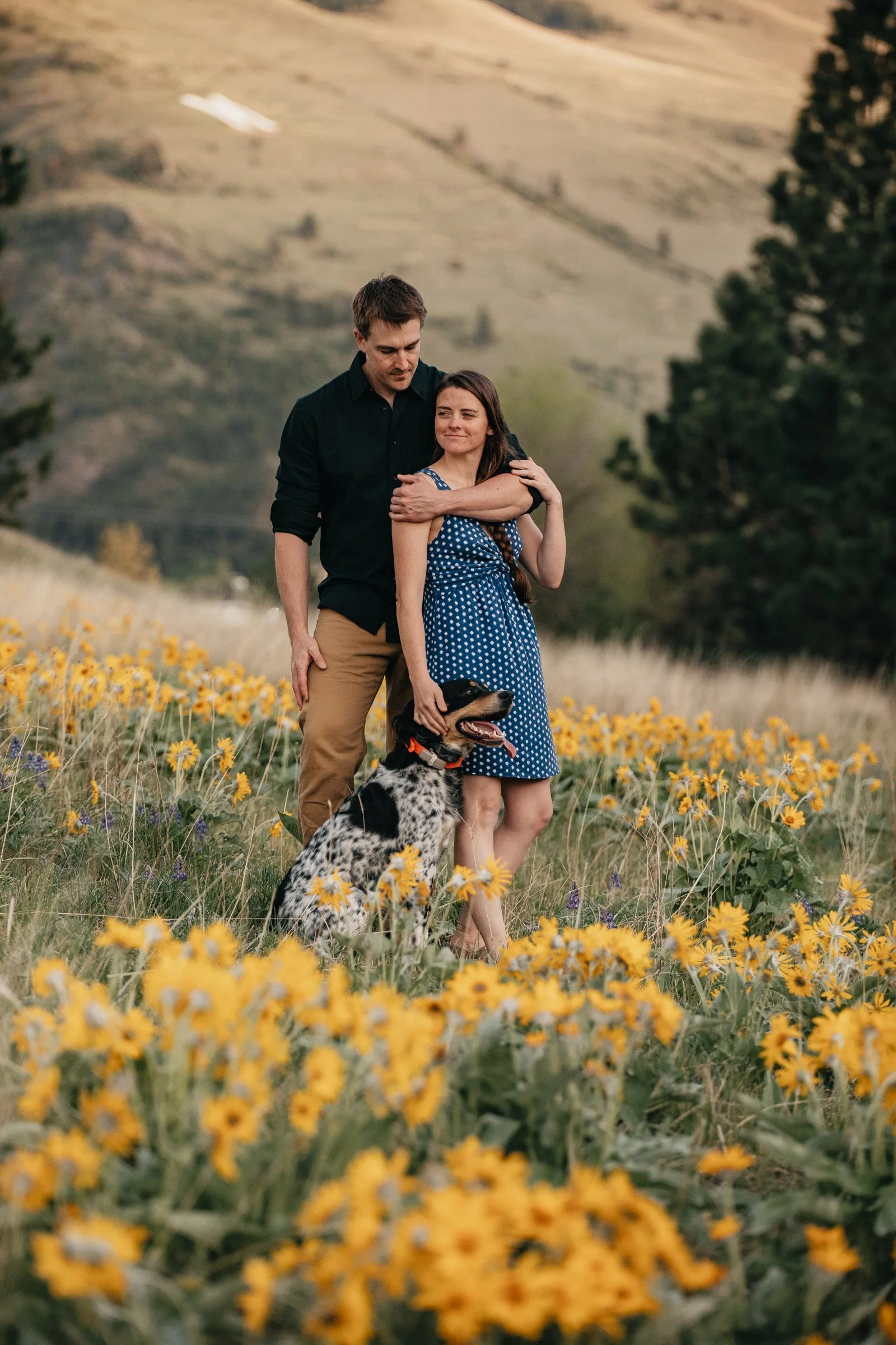 Romantic engagement photos in Montana wildflowers, blending natural storytelling with vibrant floral backdrops and scenic views.