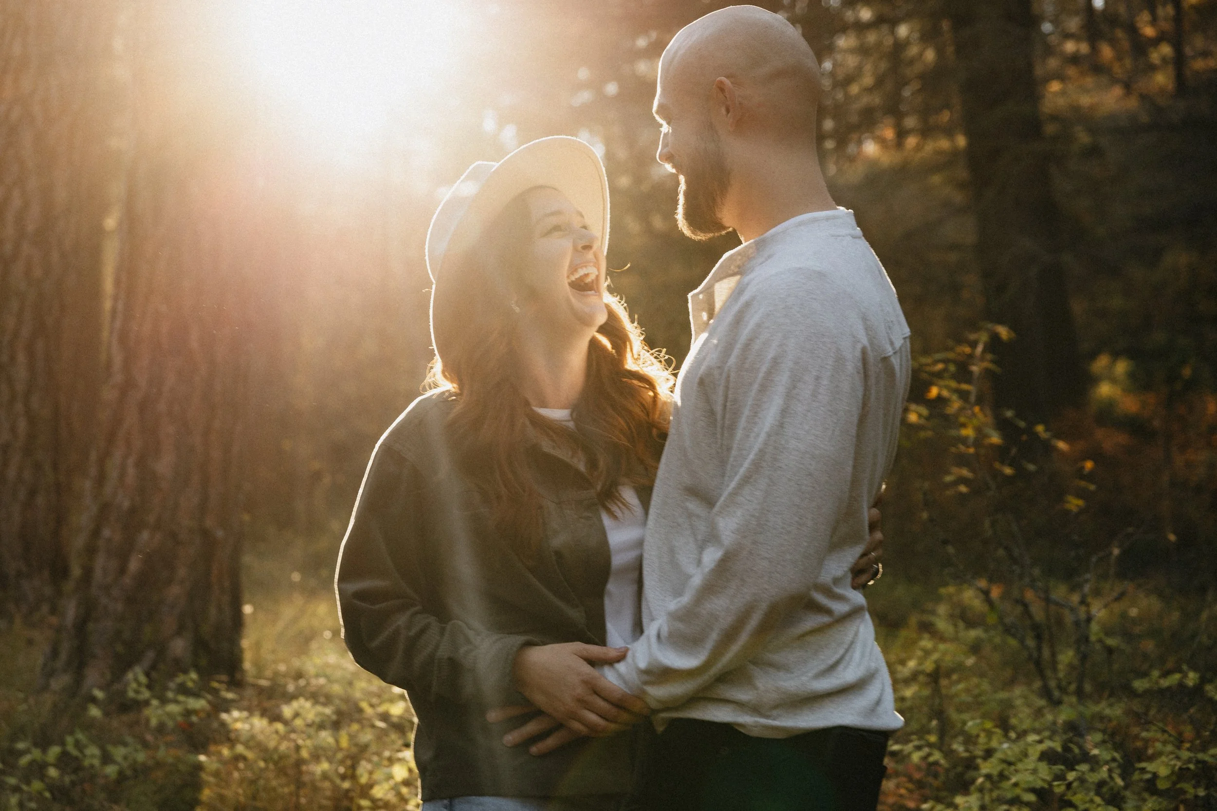 Forest engagement photos in Missoula, Montana capturing real connection among tall pines, soft light, and quiet, intimate outdoor settings.