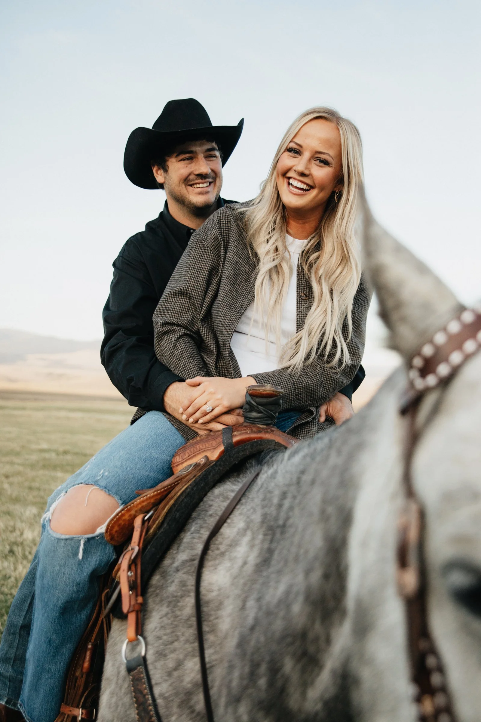 Romantic Western engagement photography in Helena, MT with a couple standing in fields under wide Montana skies.