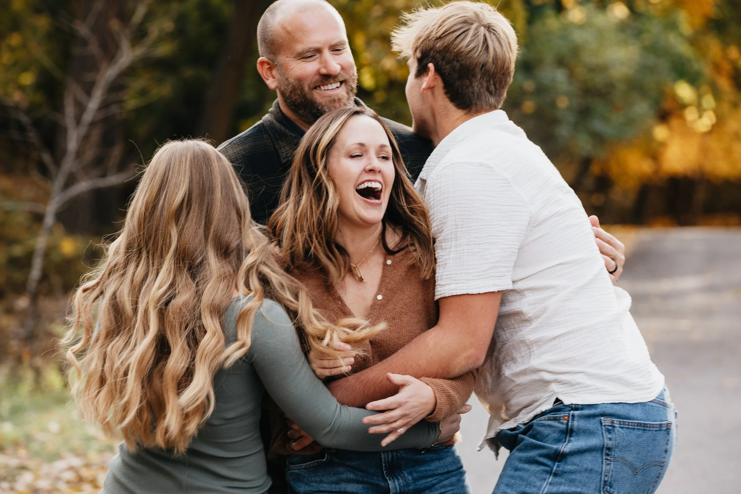 Missoula family photographer capturing families in Montana woods during Fall, highlighting colorful leaves, laughter, and natural outdoor moments.