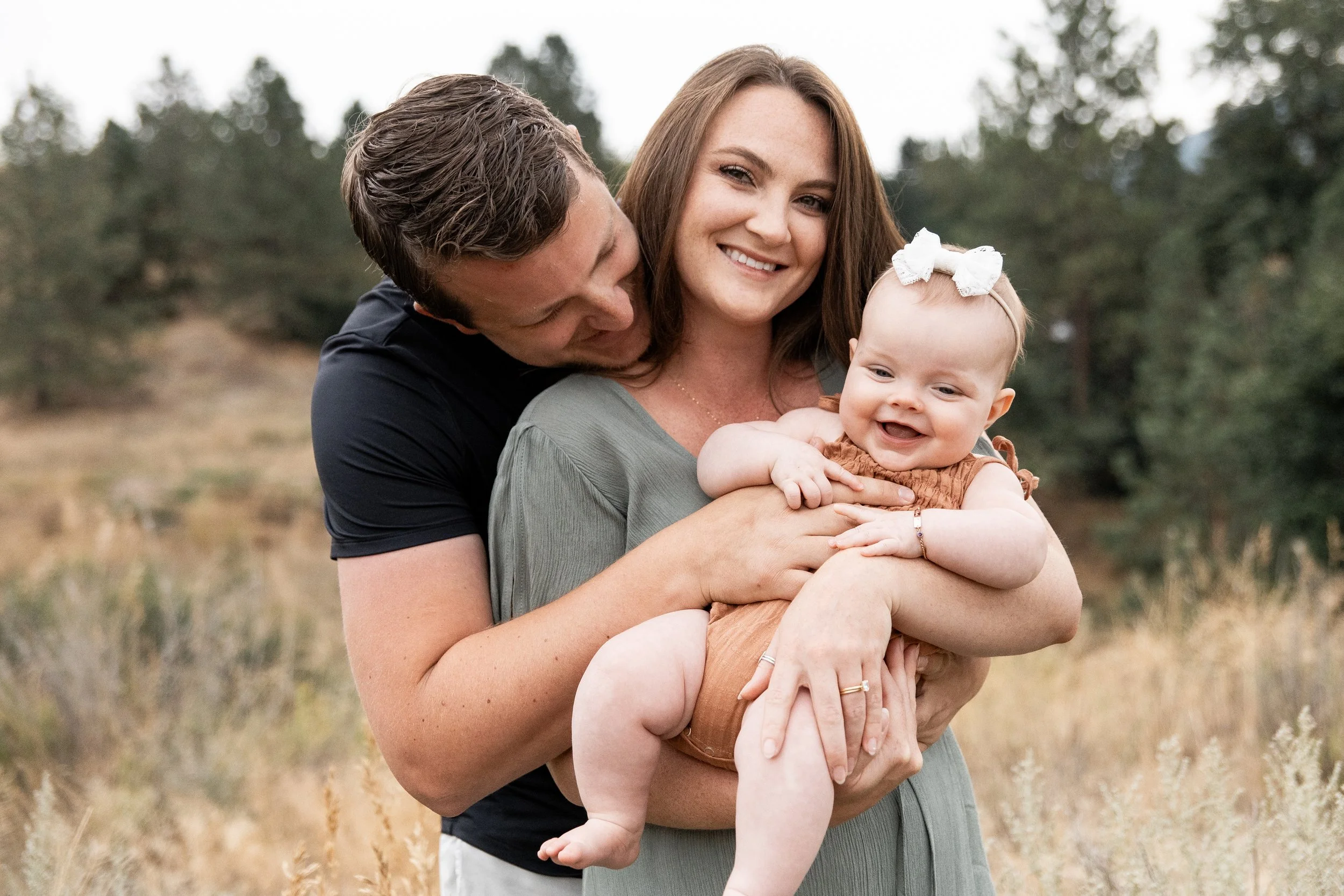 Family photography in Montana fields by a Missoula photographer, focusing on playful moments, movement, and authentic family connection.
