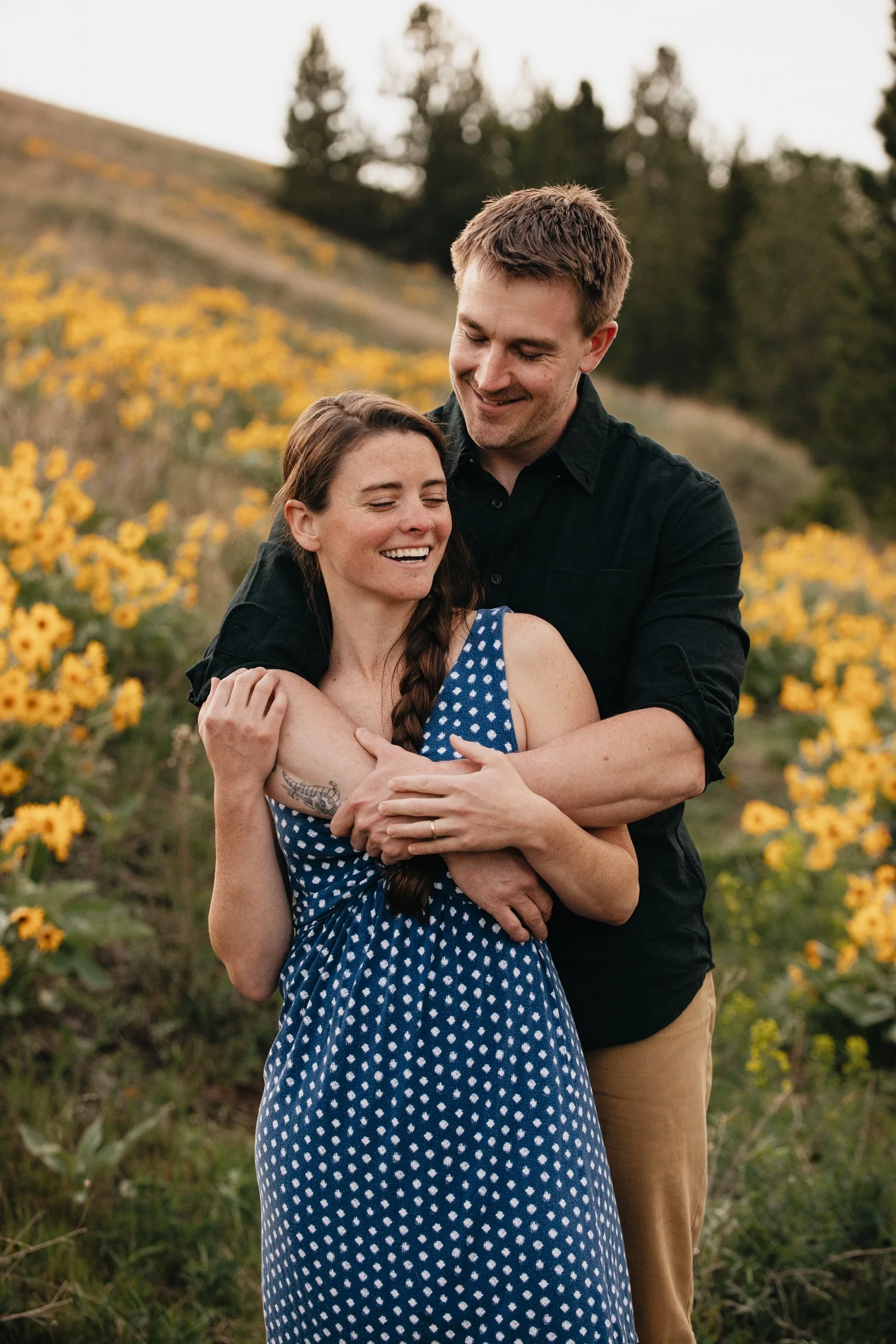 Engagement photography in Montana featuring wildflower meadows, candid moments, and authentic connection for adventurous couples.