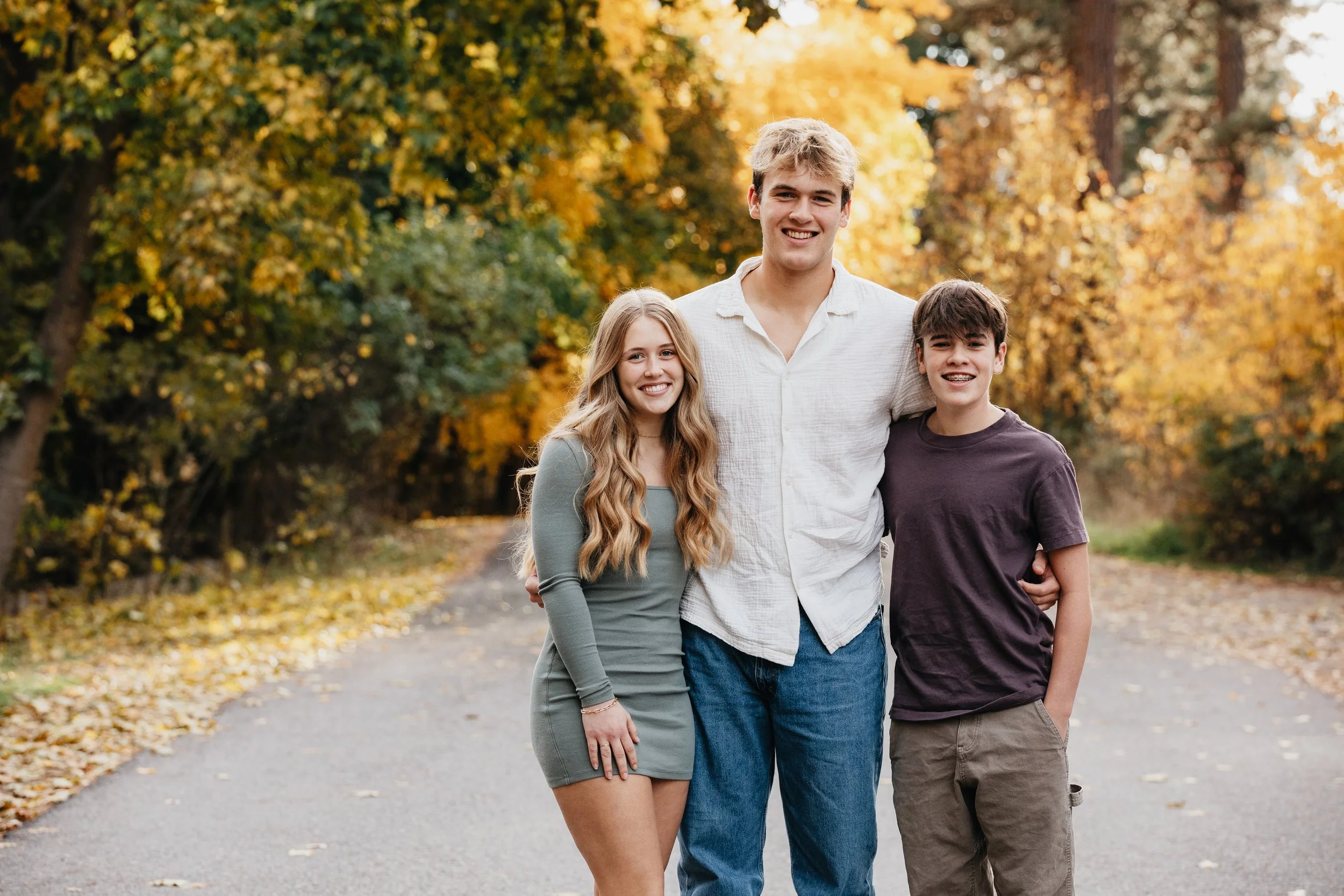 Fall family photography by a Missoula photographer in Montana forests, focusing on cozy, playful, and heartfelt moments amid vibrant autumn scenery.
