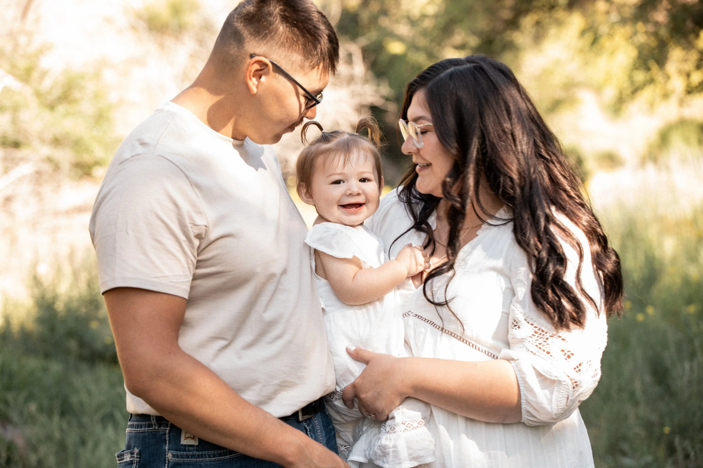 Missoula family photographer capturing a summer session with mom, dad, and their little girl in Montana, filled with warmth, laughter, and connection.
