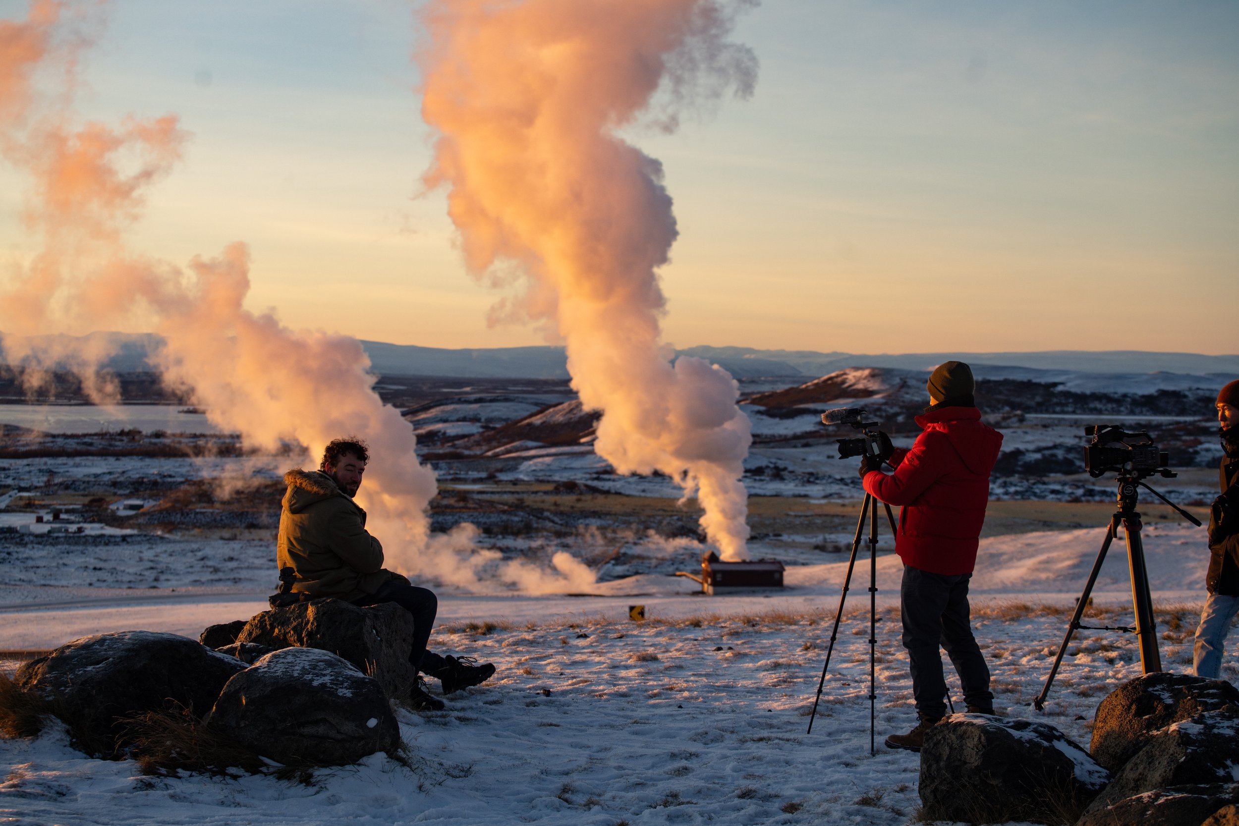 Filmmaker Ben standing in rising geothermal steam in Iceland during a documentary shoot focused on remote landscapes and natural hot springs
