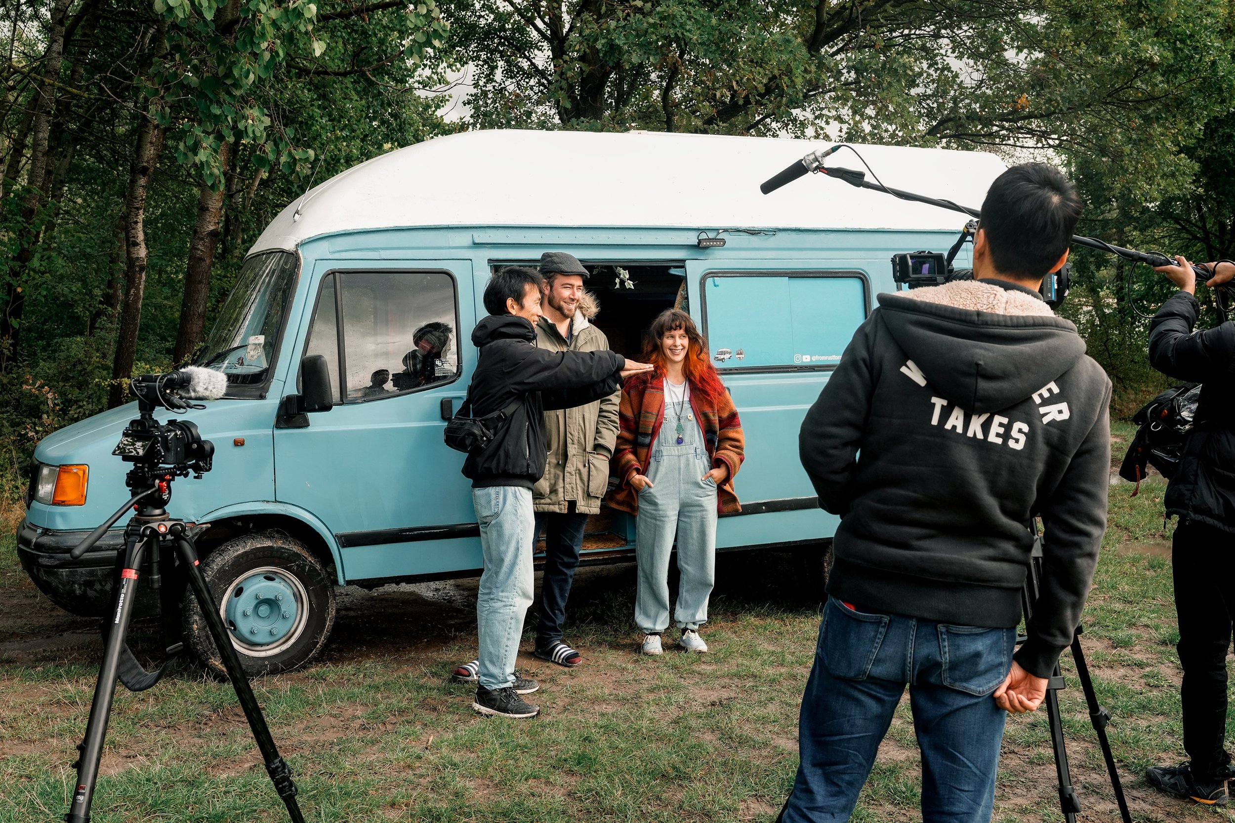 Documentary film crew working alongside Lucy and Ben outside their expedition van during remote field production in Europe