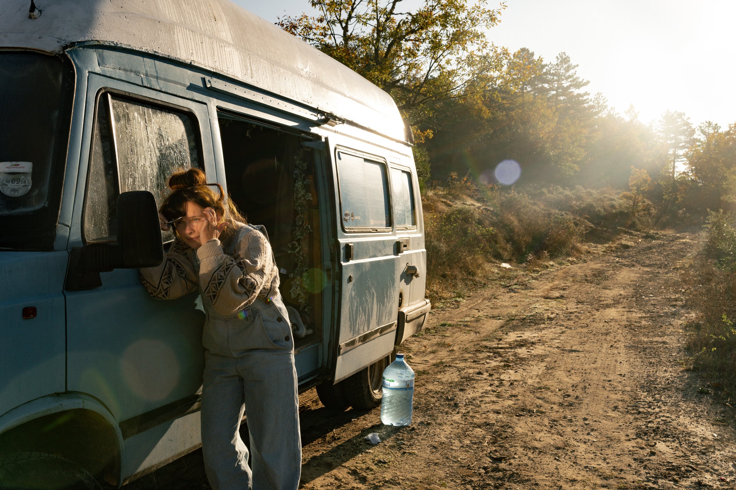 Award-shortlisted documentary photograph of Lucy outside a camper van during long-term van travel, recognised by Life Framer for intimate storytelling on the road