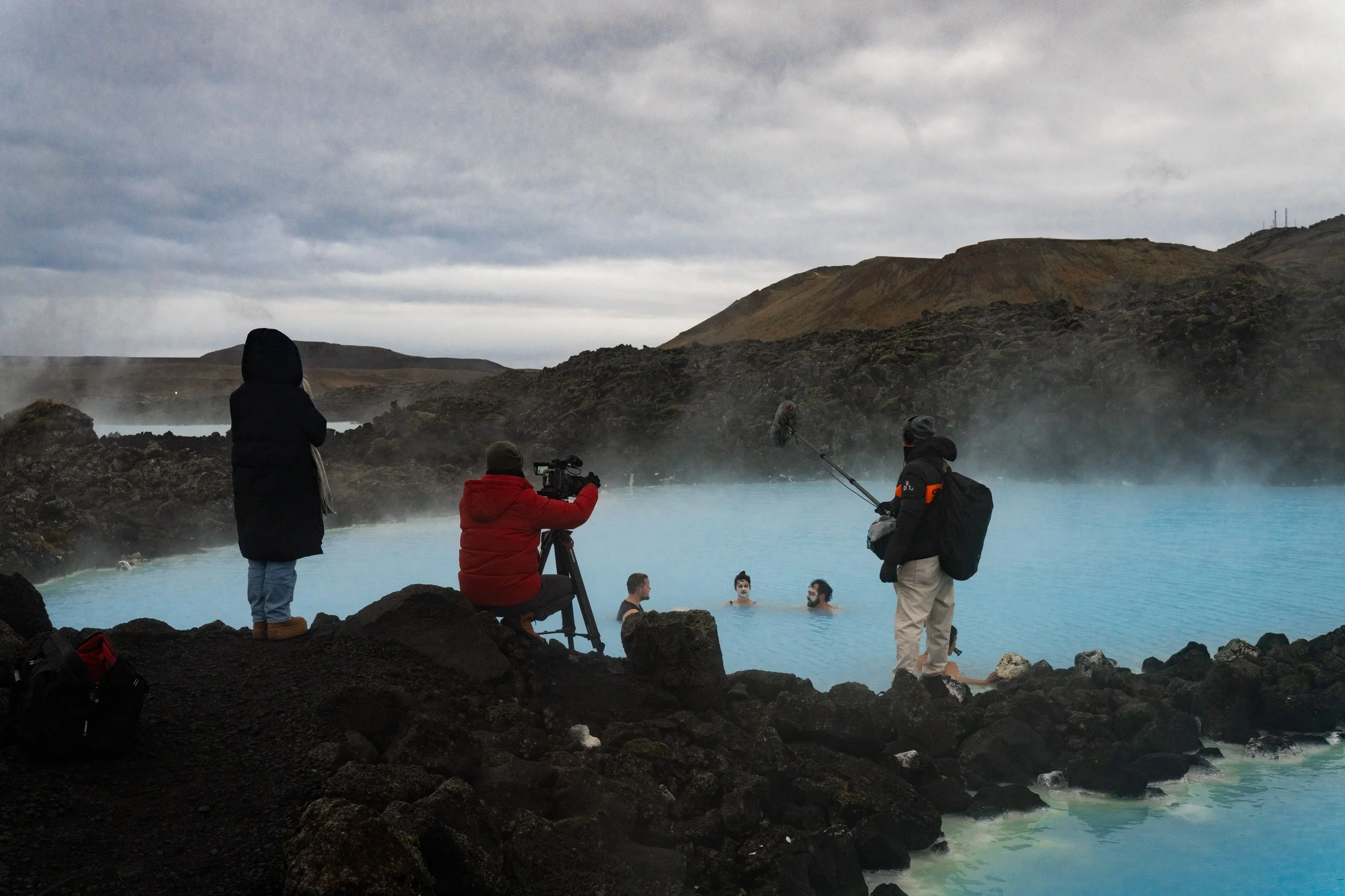 Behind-the-scenes filming at the Blue Lagoon, Iceland, with Lucy and Ben and a small camera crew documenting geothermal travel and hot spring culture