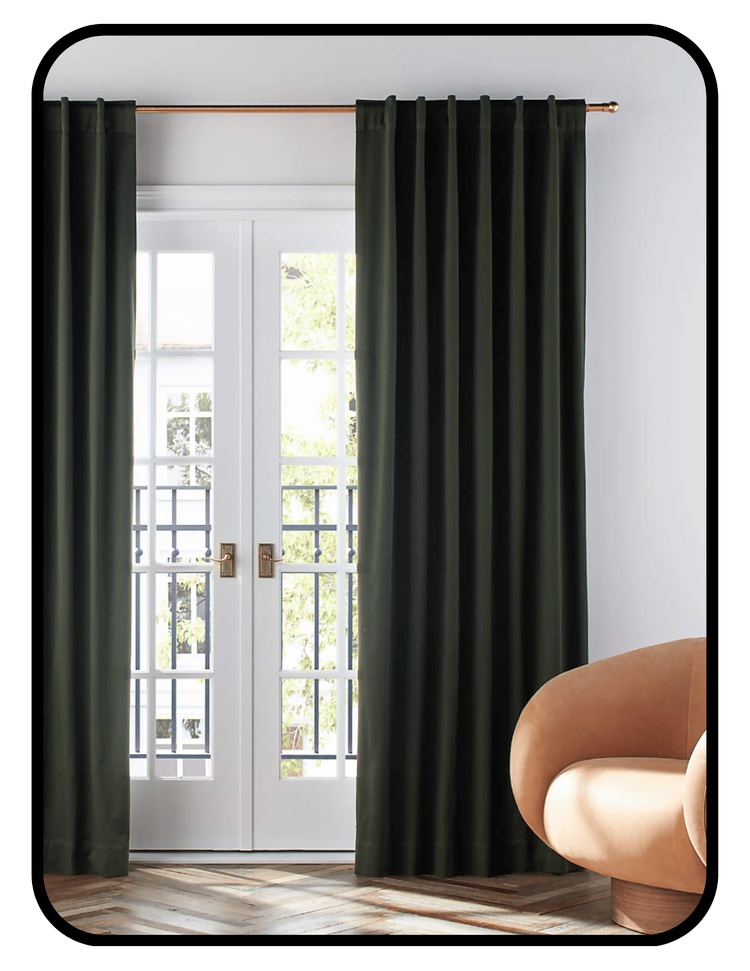 Crate and Barrel blackout curtains in a neutral tone framing a sunlit window
