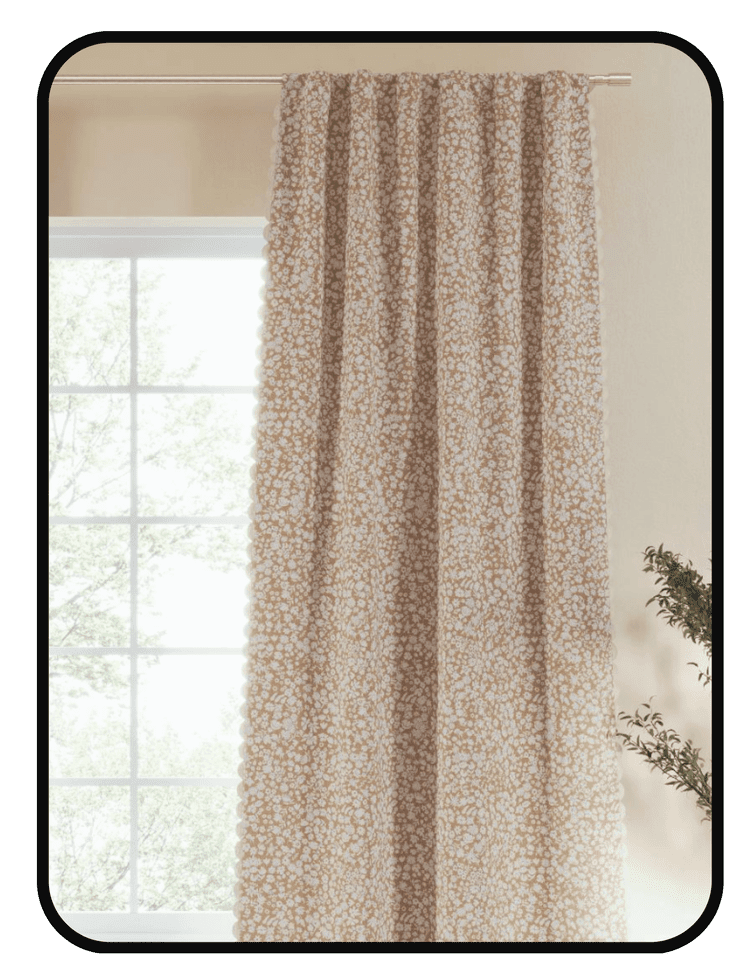 Nestig blackout curtains in a soft floral pattern hanging in a bright bedroom