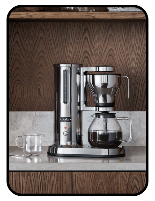 ECM Puristika espresso machine with glass water reservoir and stainless steel tubing