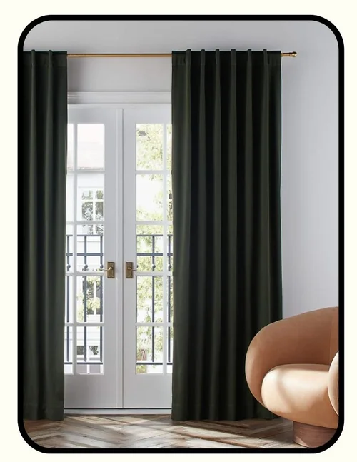 Crate and Barrel blackout curtains in a neutral tone framing a sunlit window
