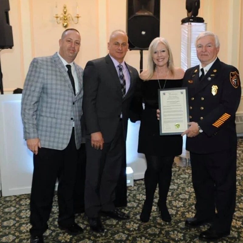 Brian, Howie, and Debbie presenting a proclamation