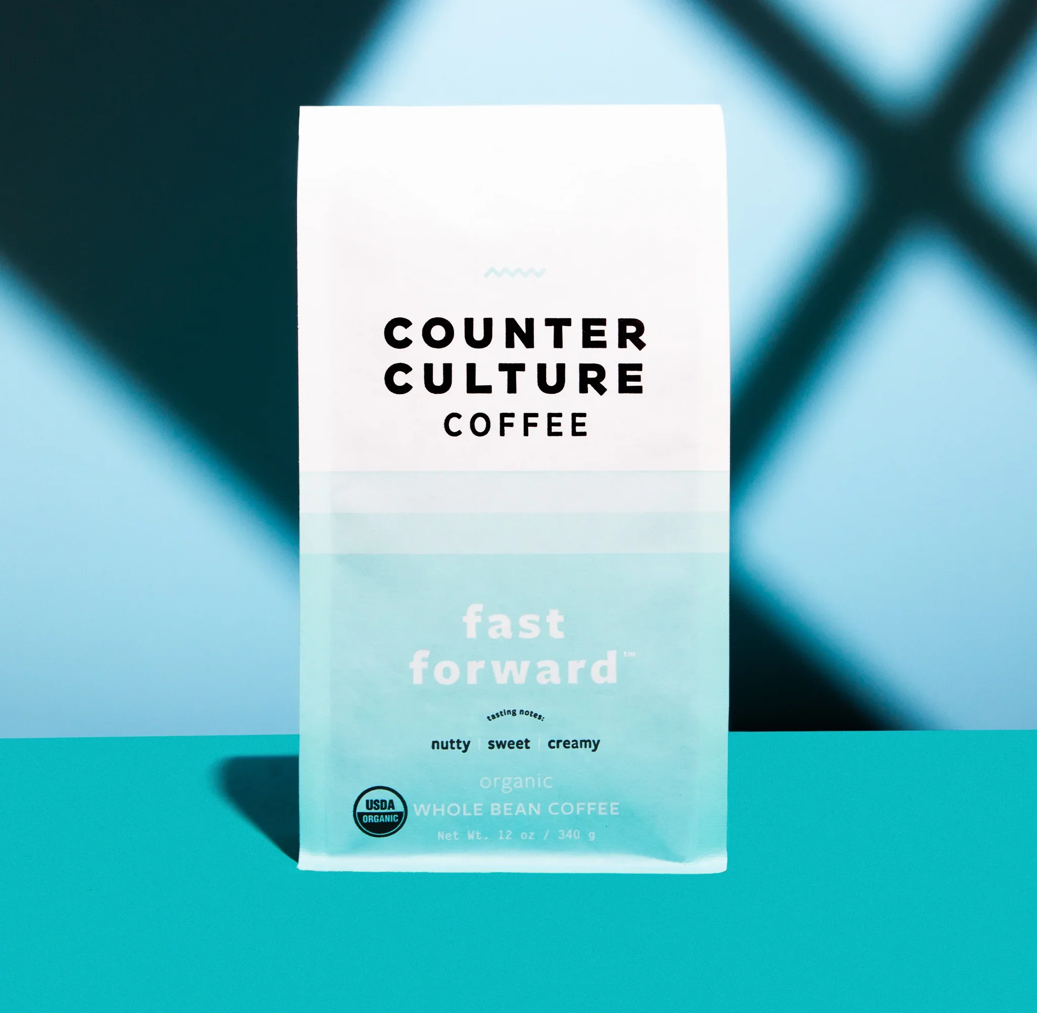 Counter Culture Coffee Fast Forward blend packaging — light blue gradient organic whole bean coffee bag