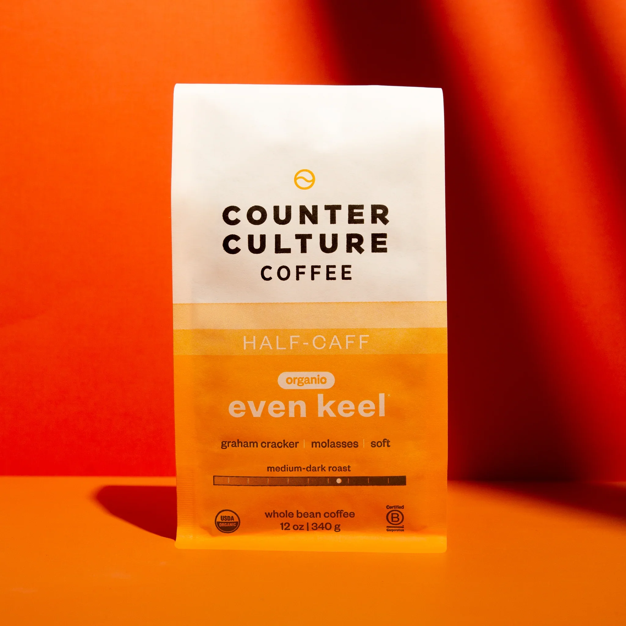 Counter Culture Coffee Even Keel half-caff blend packaging — orange gradient organic whole bean coffee bag