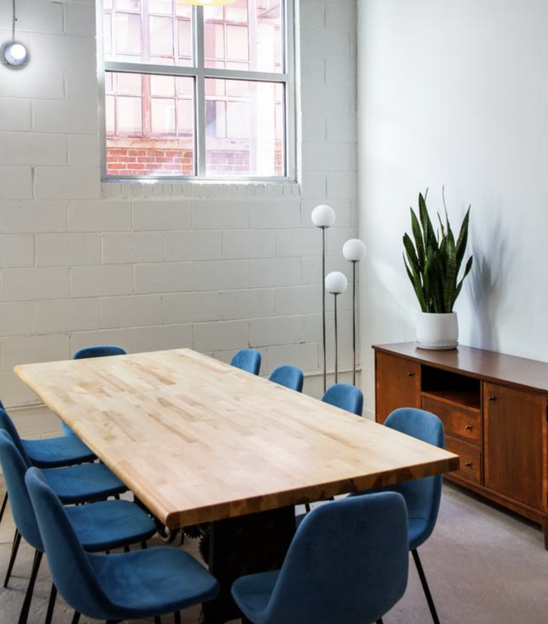 Counter Culture Coffee Atlanta Training Center meeting room — light wood tables with teal chairs
