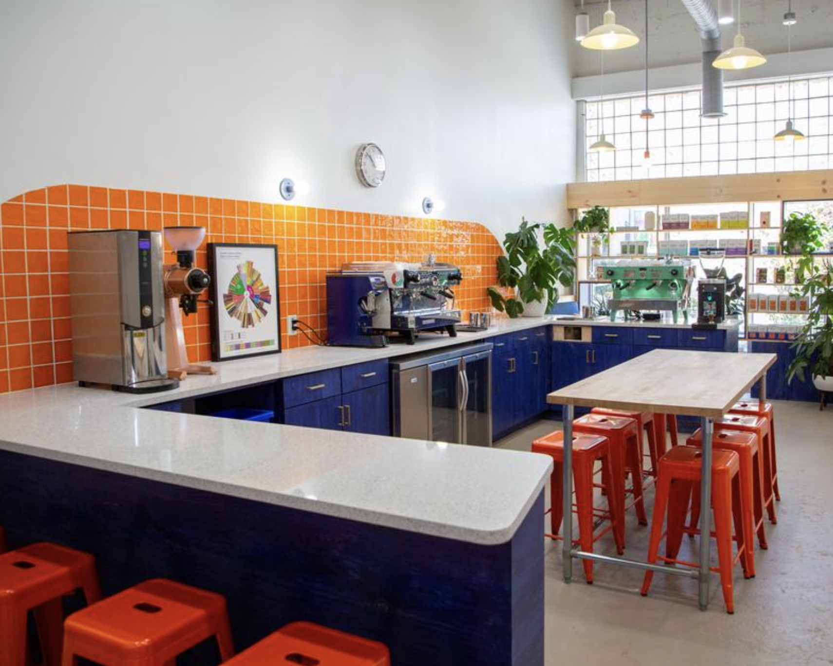 Counter Culture Coffee Atlanta Training Center interior — navy blue cabinetry with orange tile backsplash and orange stools