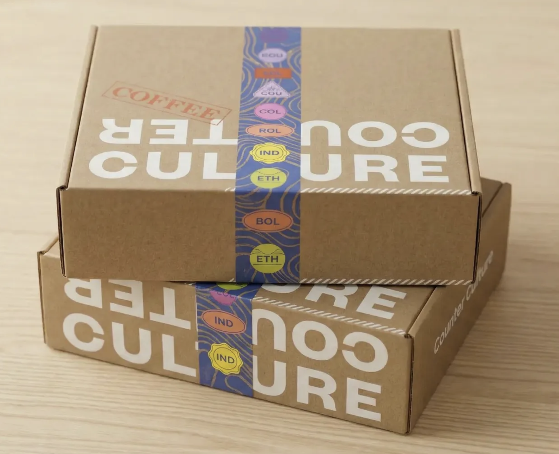 Counter Culture Coffee Club subscription box exterior — kraft mailer box with bold typographic Counter Culture branding and illustrated tape