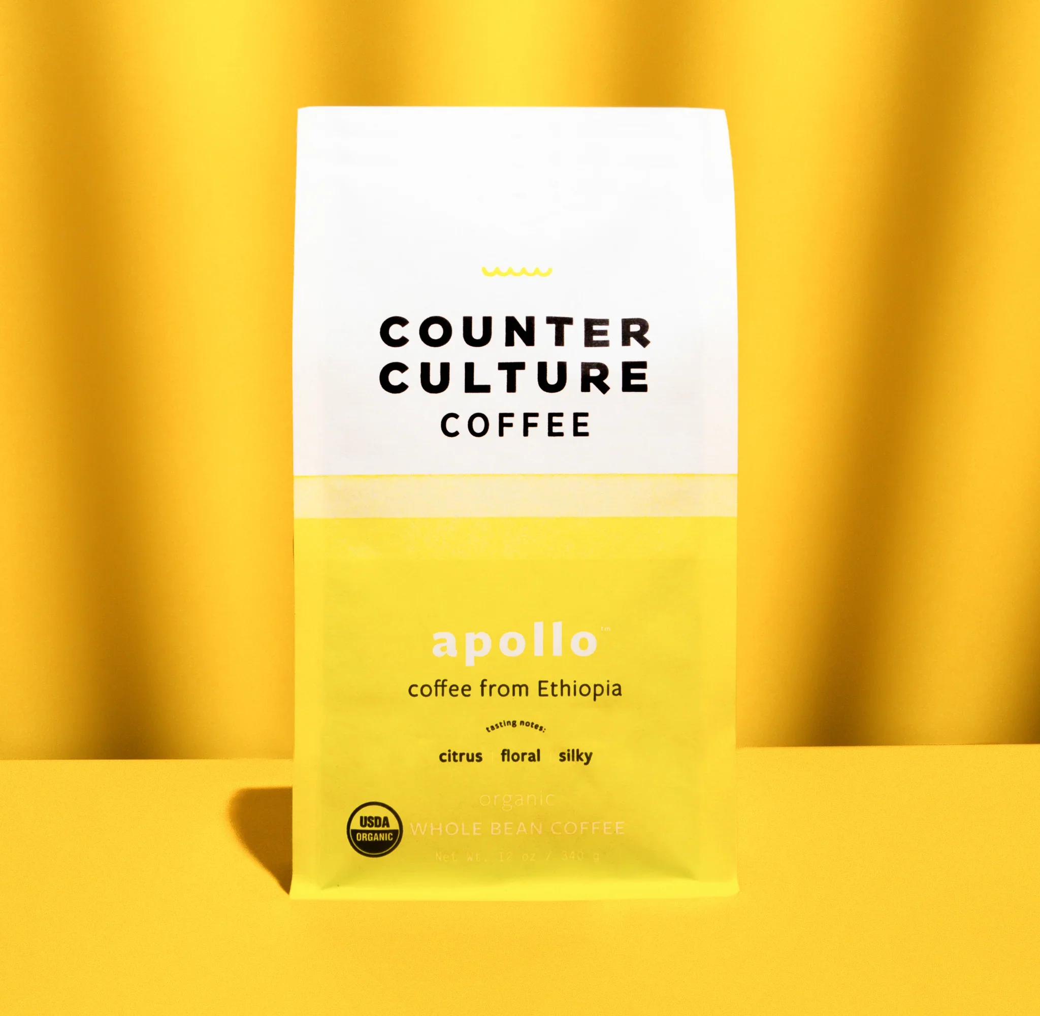 Counter Culture Coffee Apollo Ethiopian coffee packaging — yellow gradient organic whole bean coffee bag