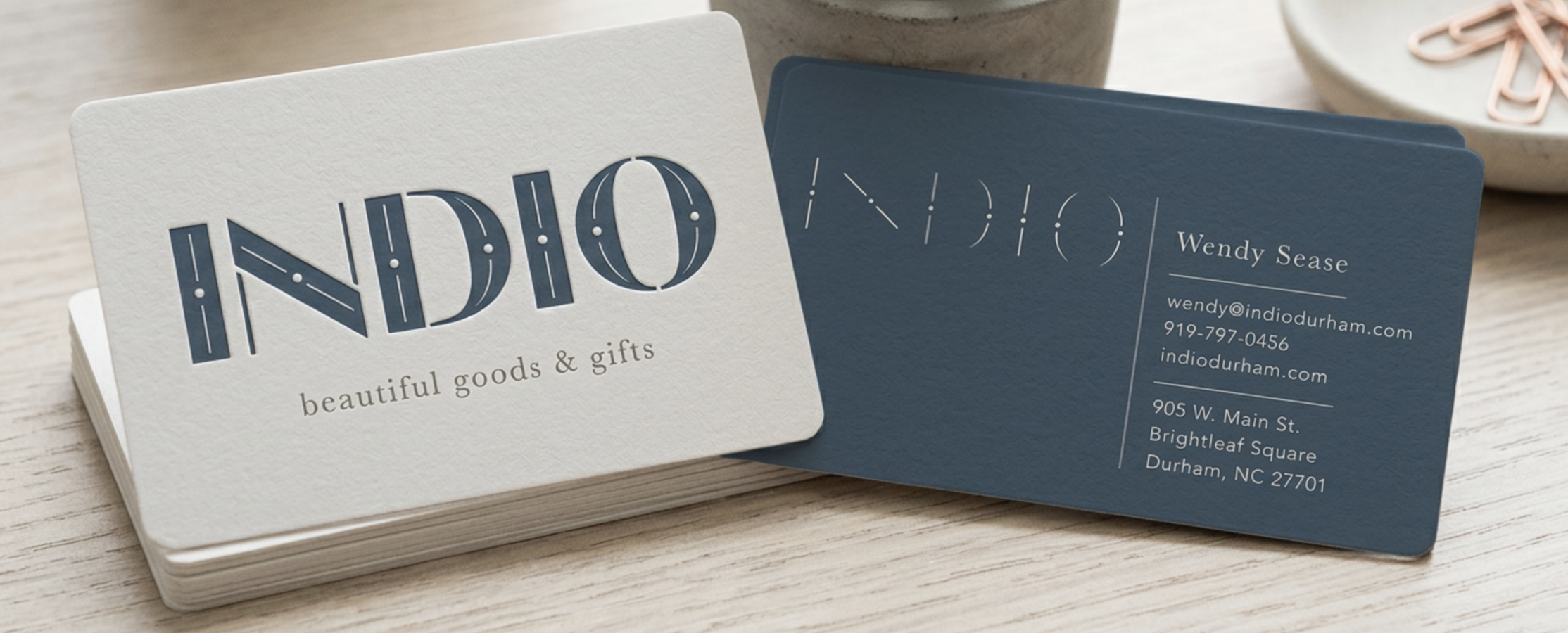 Indio Durham business cards — two-sided slate blue and cream cards with logo and contact information