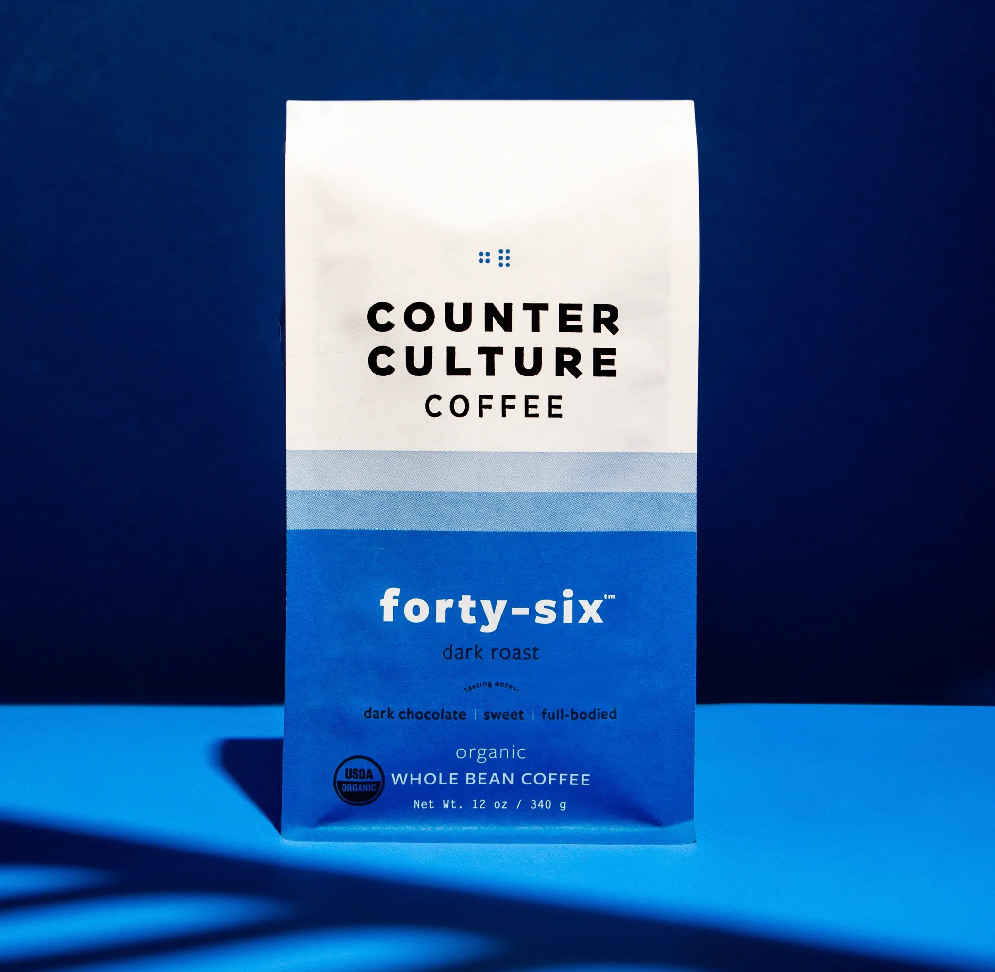 Counter Culture Coffee Forty-Six dark roast packaging — navy blue gradient  organic whole bean coffee bag